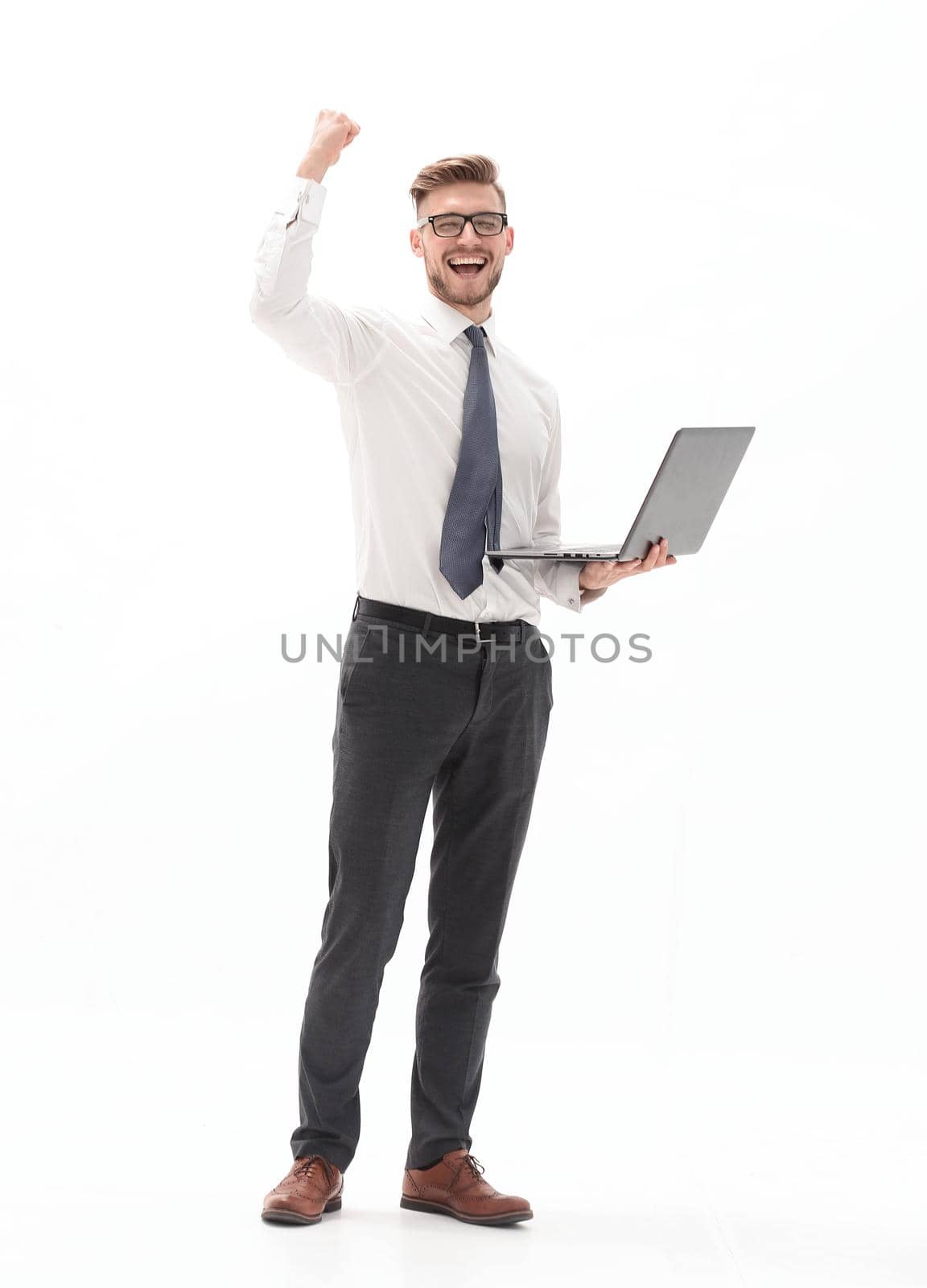 in full growth. happy businessman holding open laptop.photo with copy space