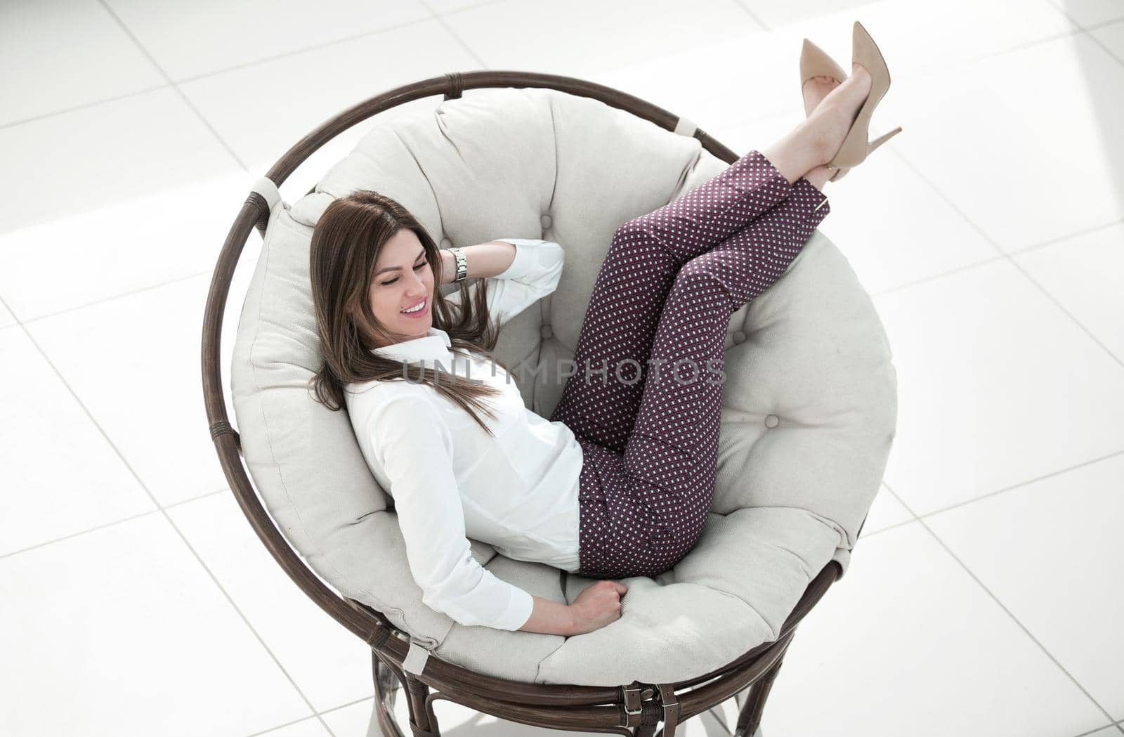 modern young woman sitting in comfortable round chair.the concept of comfort