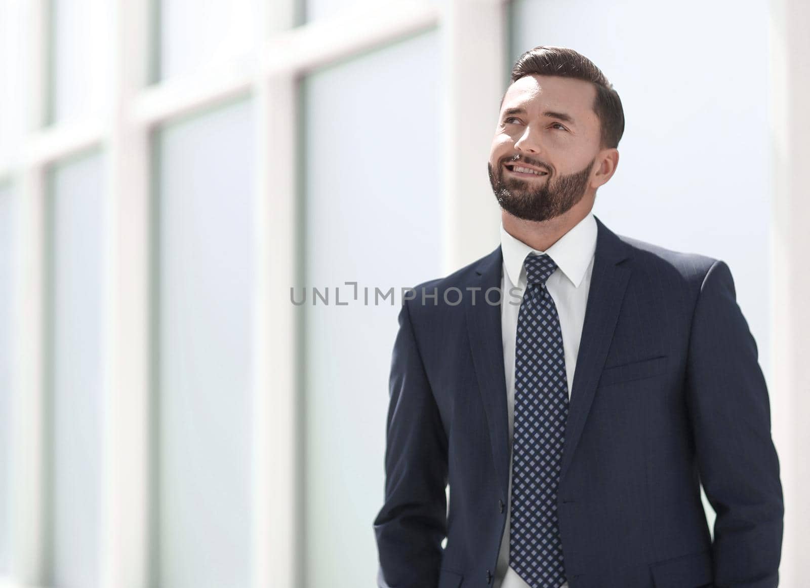 dreaming businessman standing in a bright office.photo with copy space