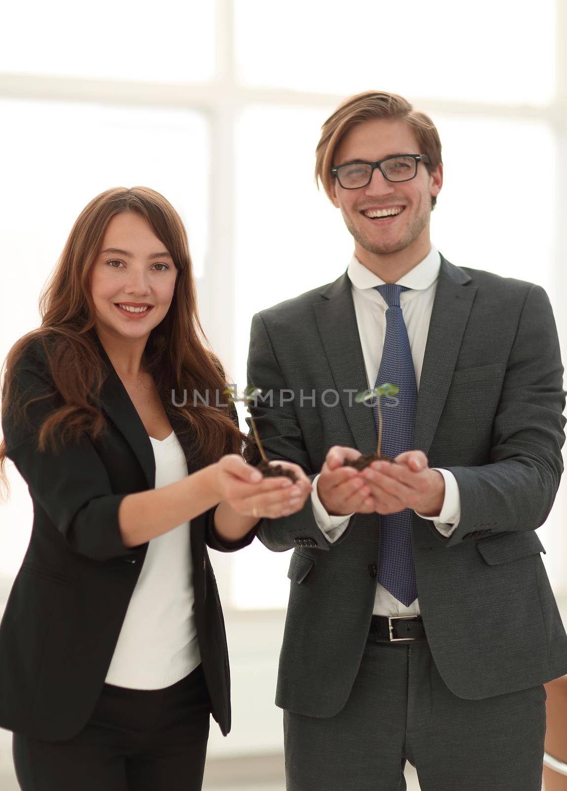 business couple holds in their hands the tender shoots.the concept of a startup