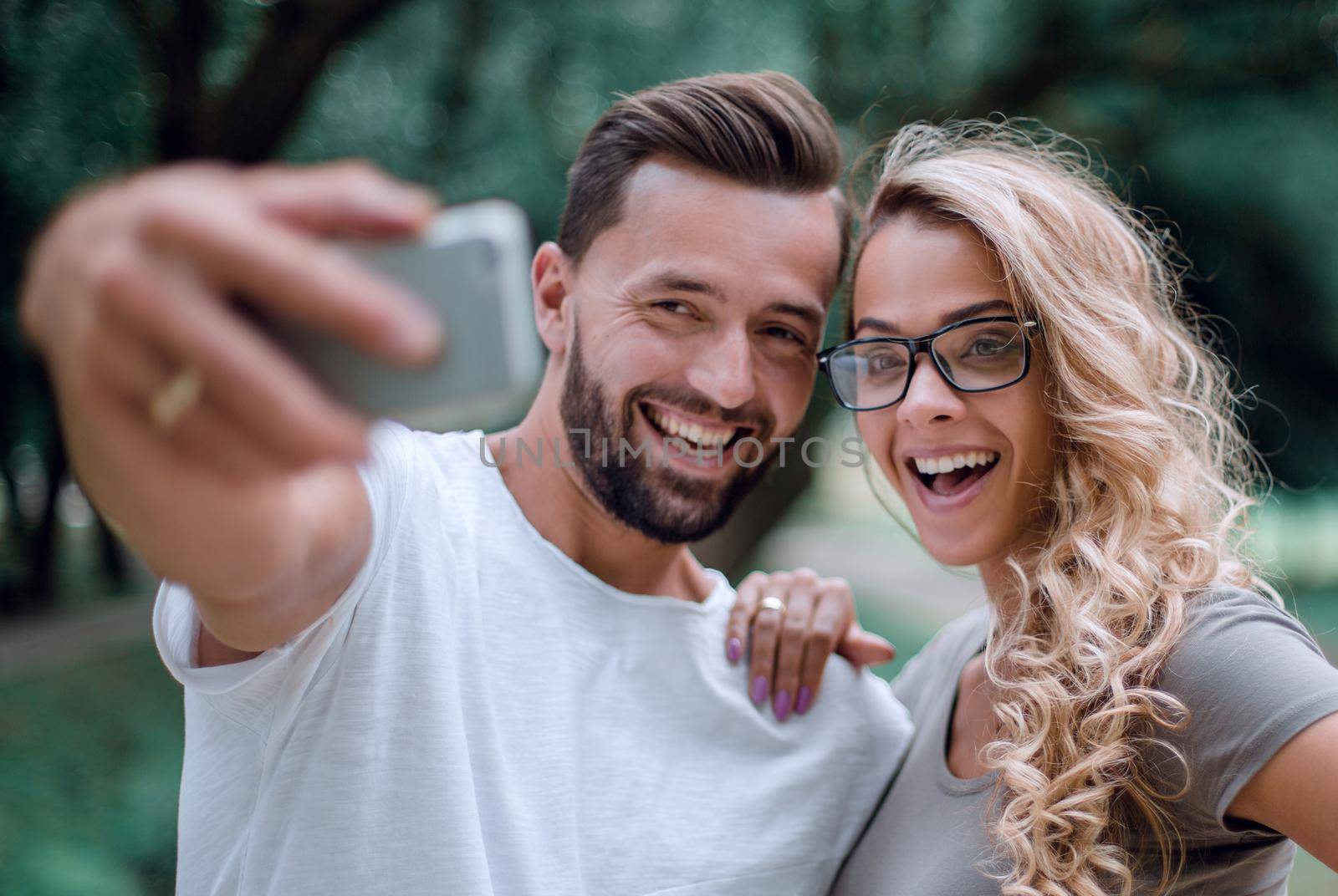 close up.smiling young couple taking selfie in city Park.photo for memory