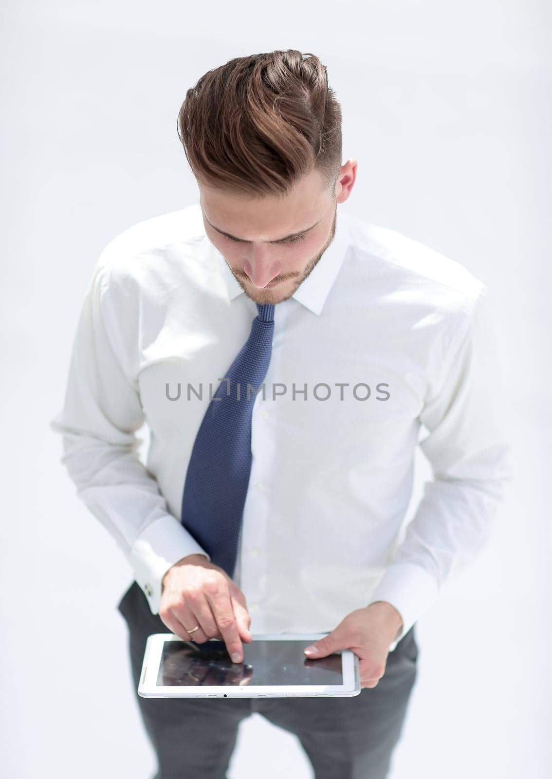 confident man in a shirt and tie works on a digital tablet by asdf