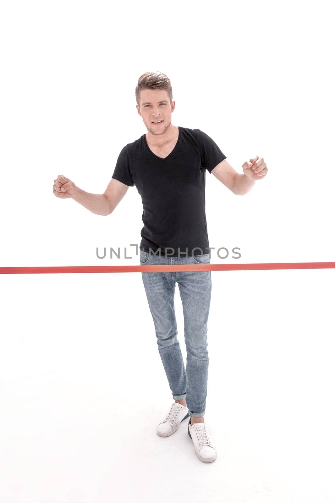 Cheerful man crossing red finish line