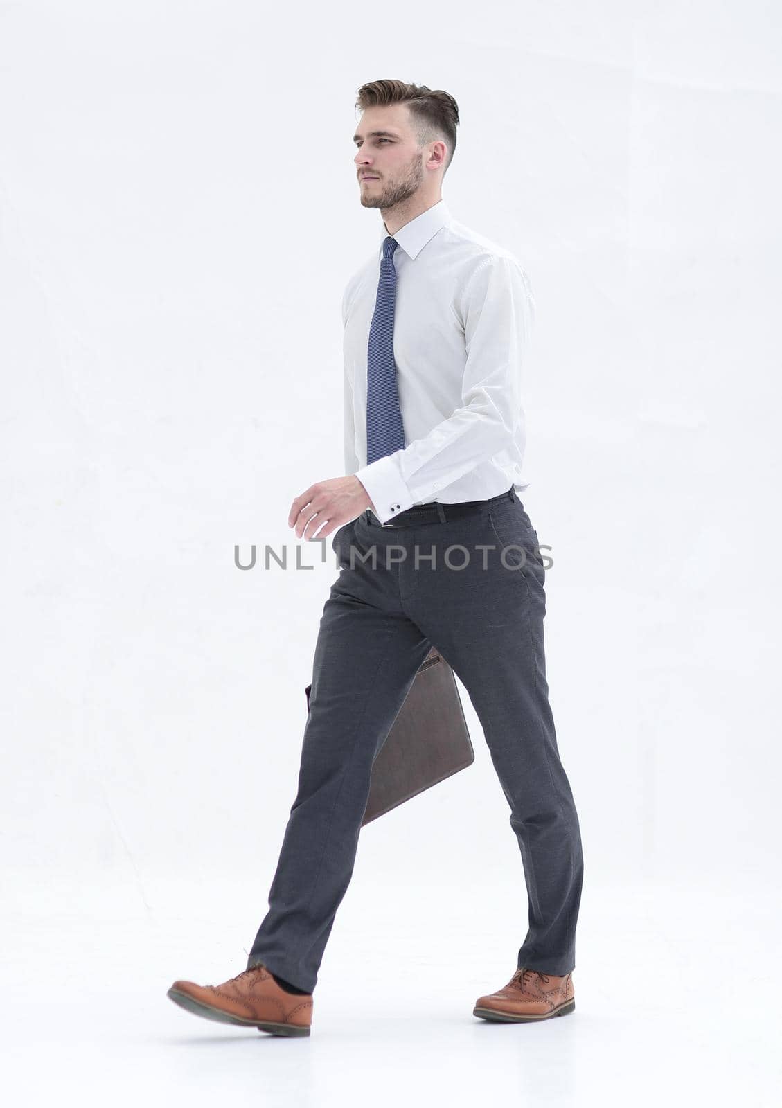 side view.businessman with a leather briefcase steps forward by asdf