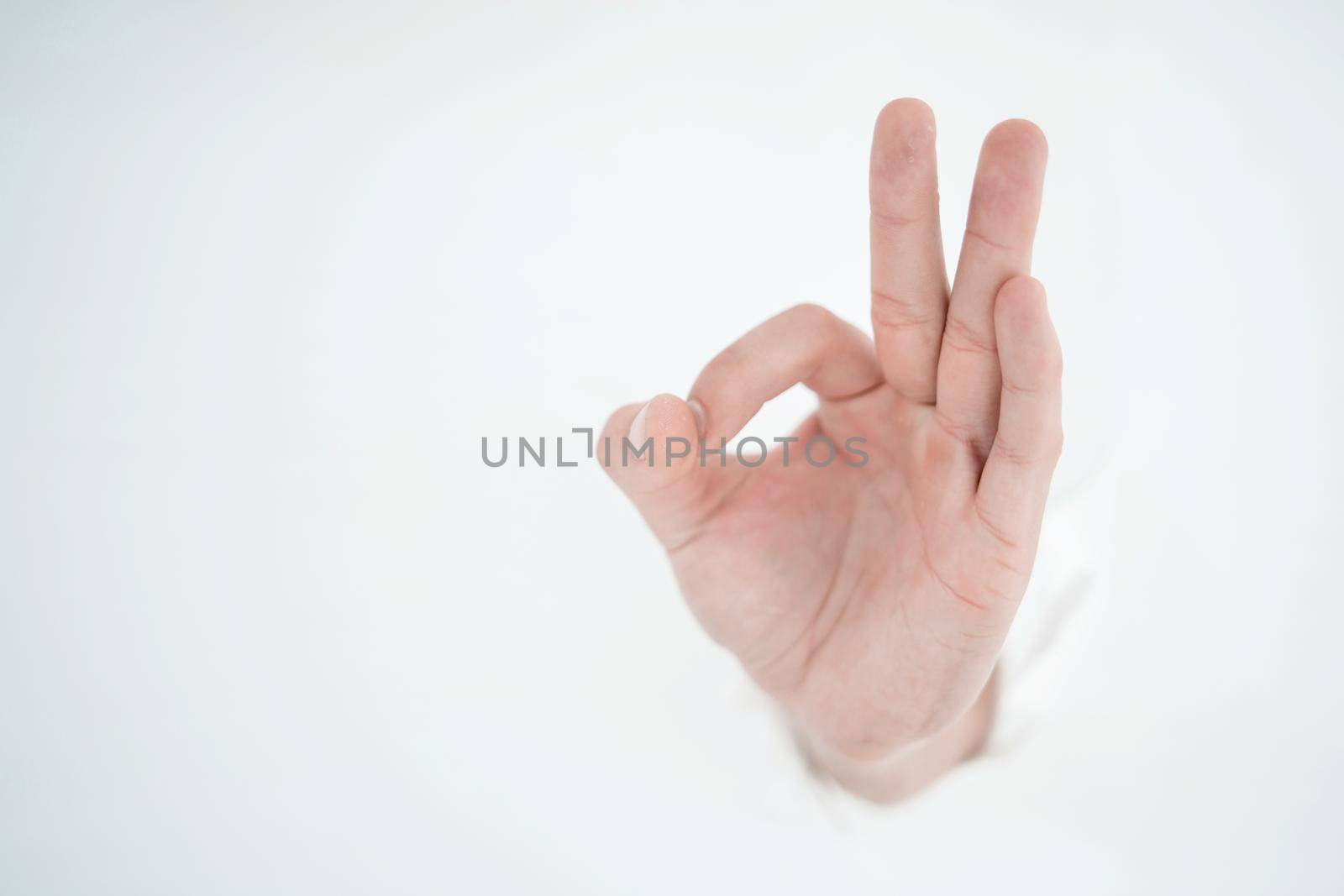 man's hand breaking through the paper wall and pointing at you by asdf