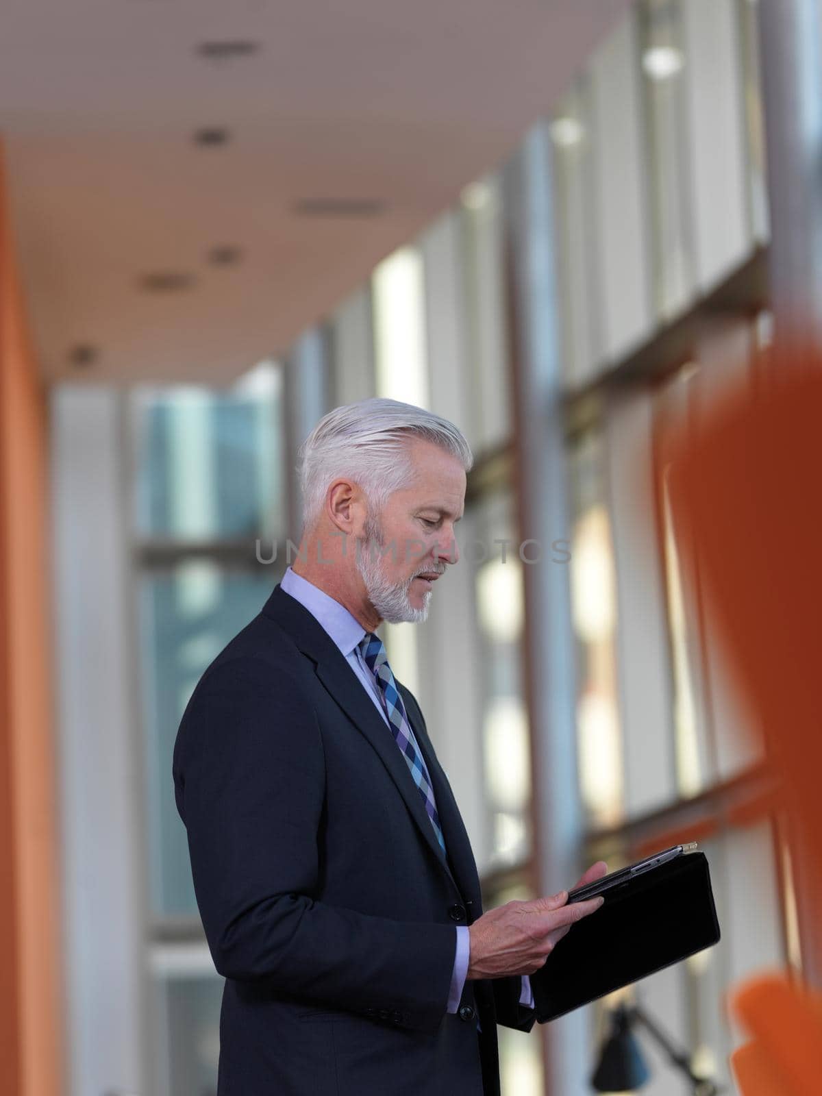 senior business man working on tablet computer at office