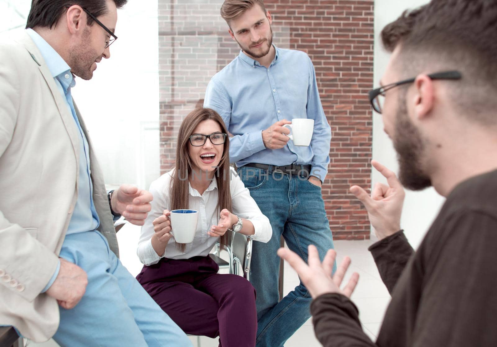 business team talking and smiling during coffee break in office. the concept of teamwork