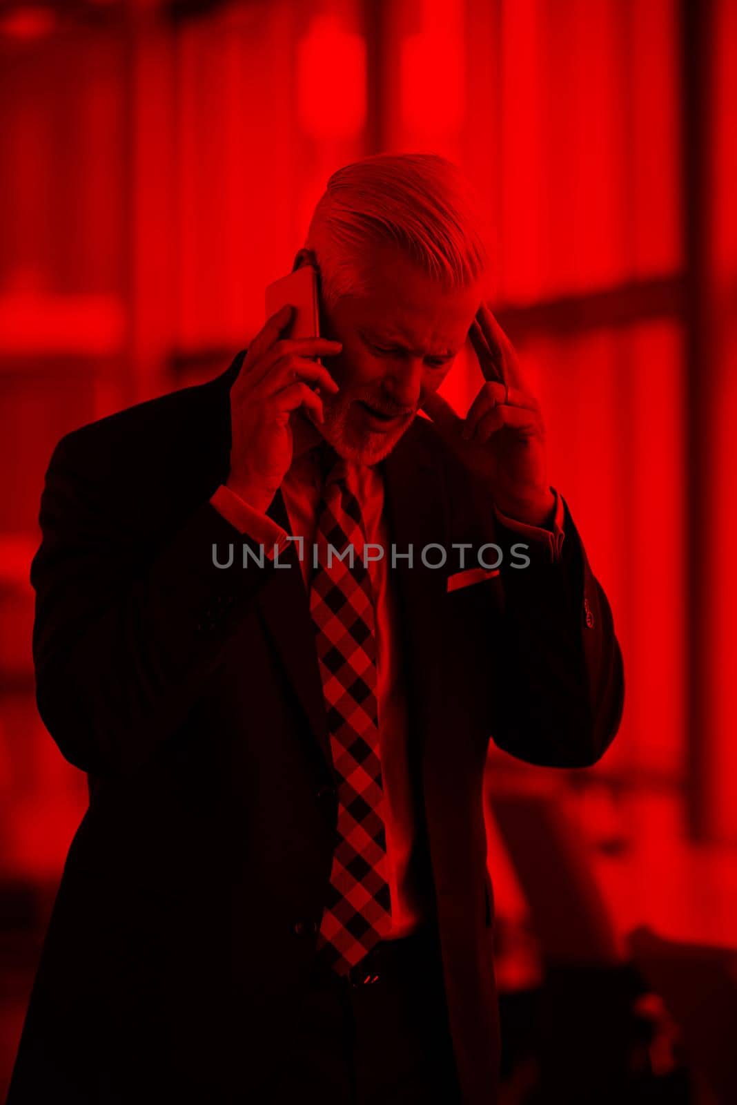 senior business man talk on mobile phone  at modern bright office interior