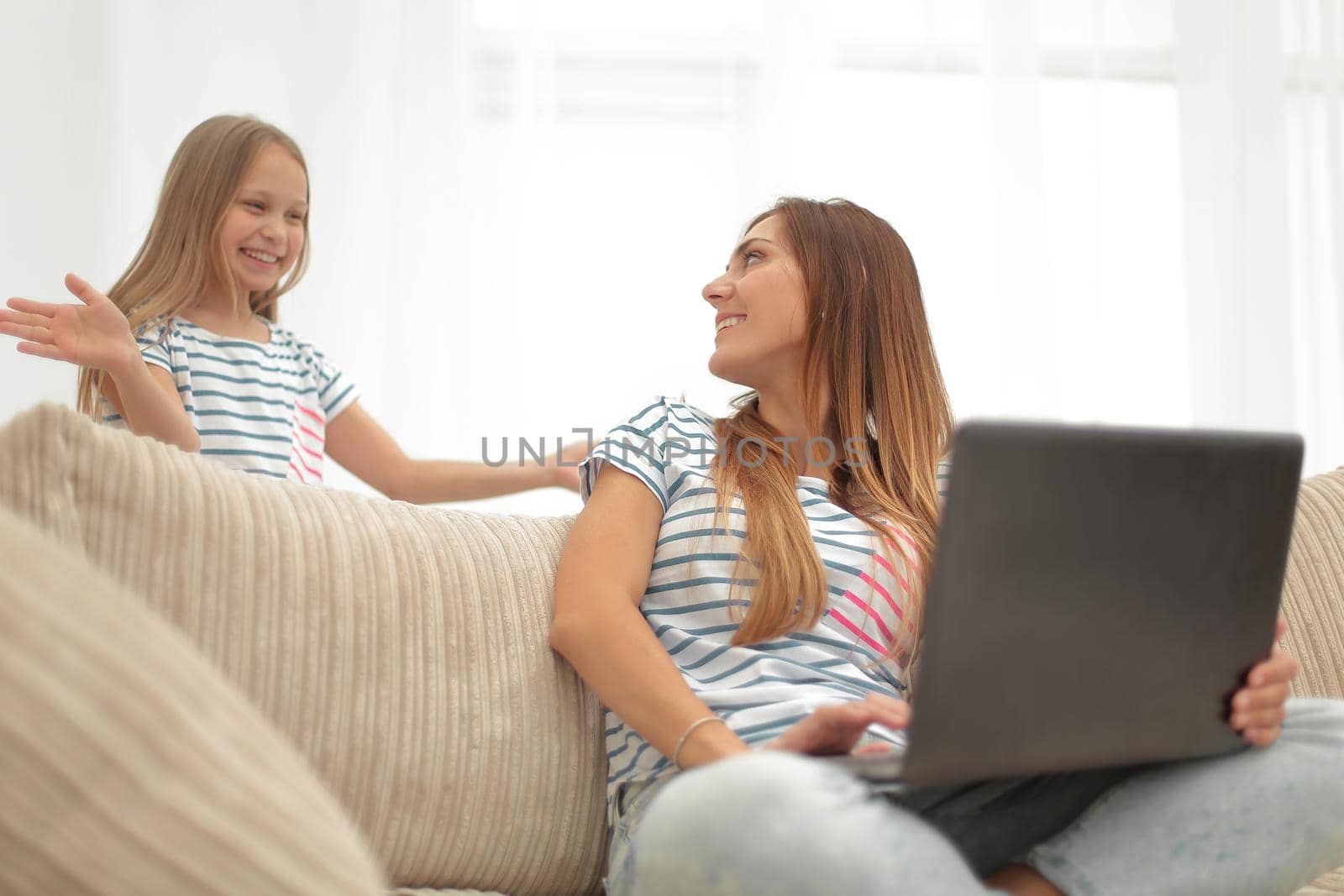 mom and her daughter are resting in the living room by asdf