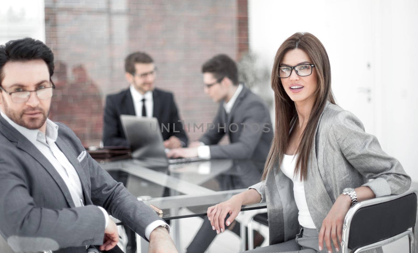 businessman and business woman sitting at the Desk.business concept