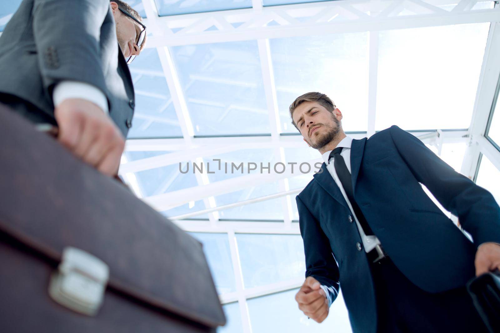 Business deal concept. Men in suit with documents and briefcase ready for exchange.