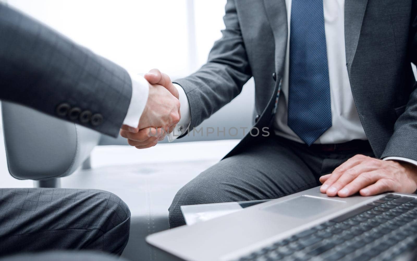 close up.handshake business partners over the Desk. by asdf