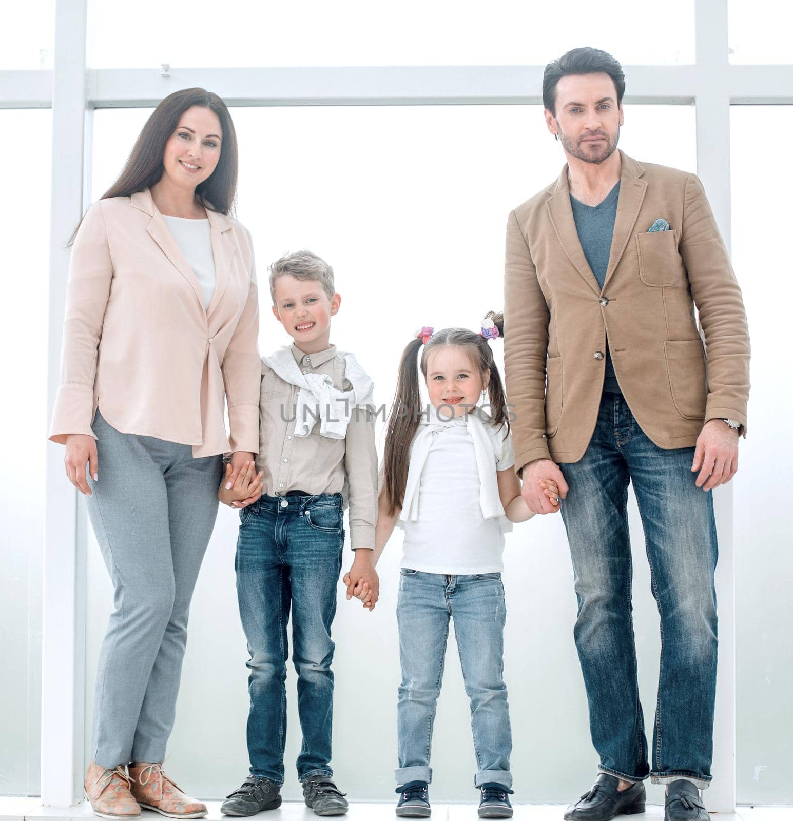 portrait of a modern family standing near a large window by asdf