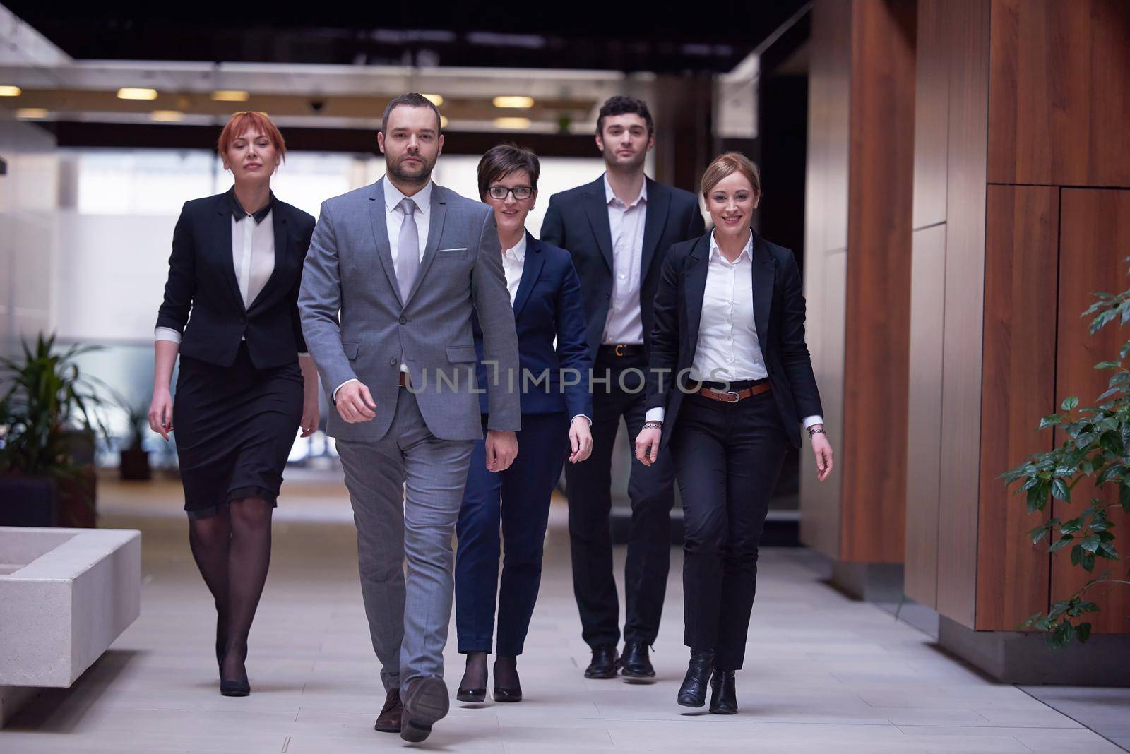 young business people team walking, group of people on modern office hall interior