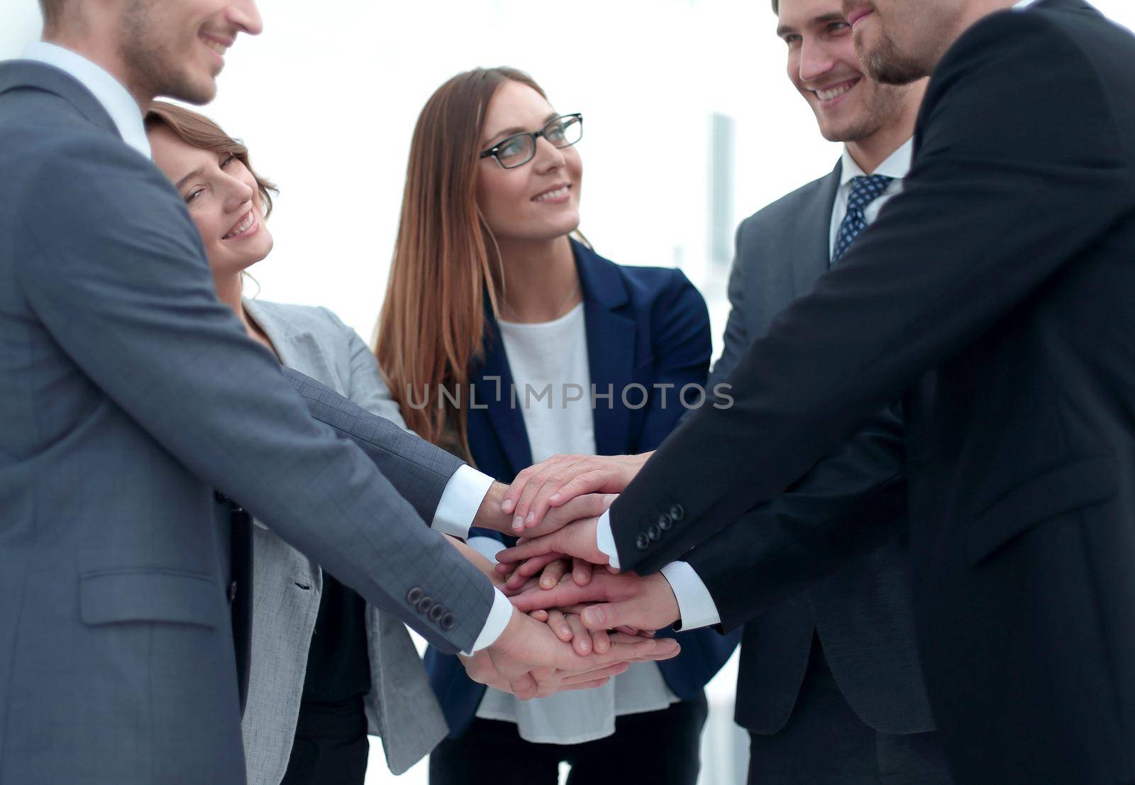 Close-up of people holding hands together while by asdf