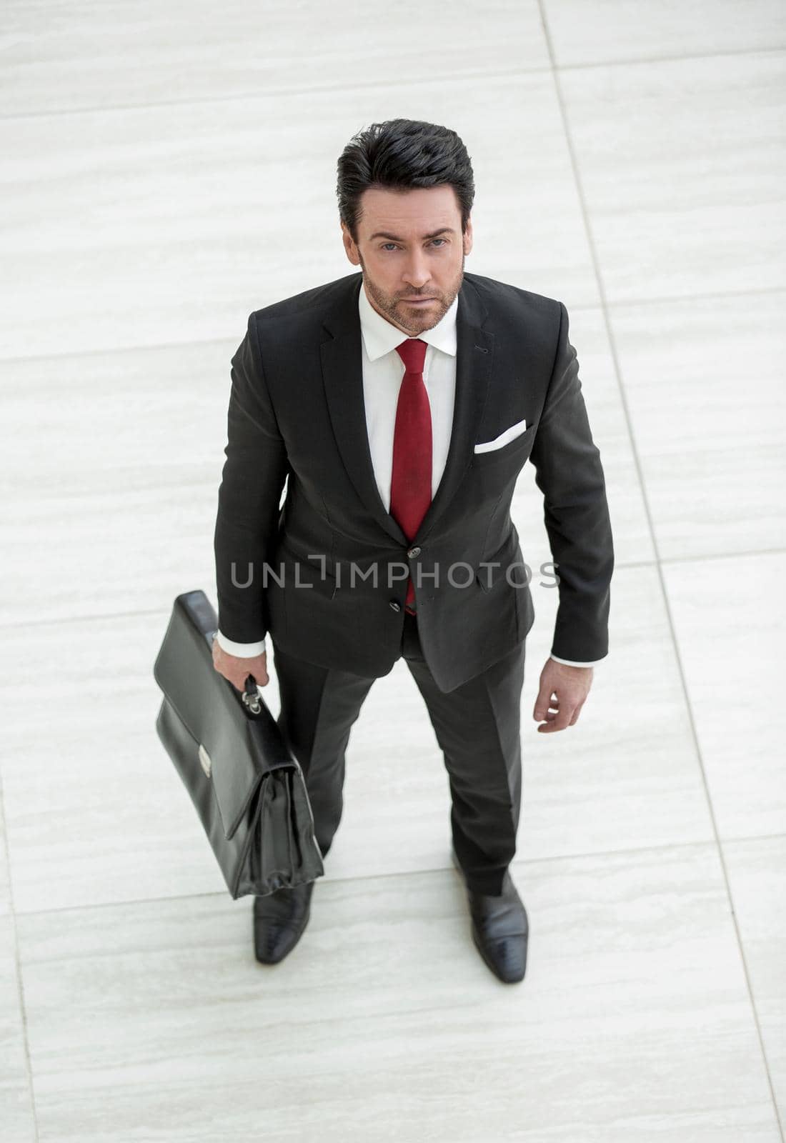 top view.confident businessman with leather briefcase . isolated on light background