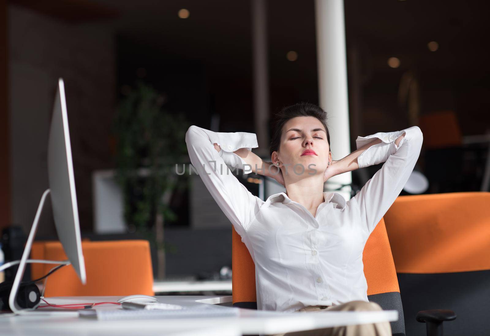 happy young business woman relaxing and geting insiration while working on desktop computer at modern bright  starup office interior