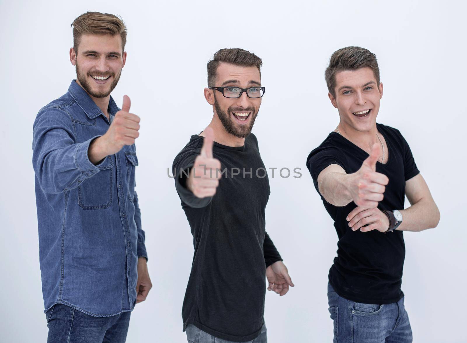 three young happy people with thumbs up sign in casual, isolated on white background.