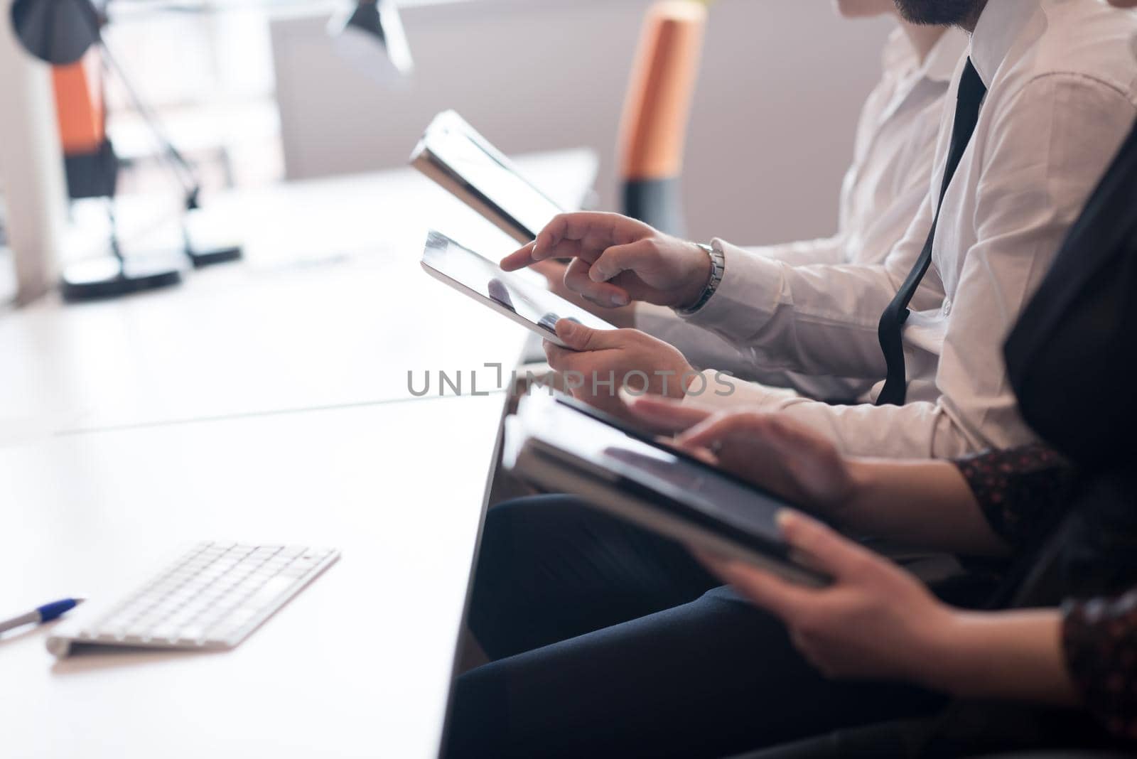 group of business people on meeting  using tablet computer in modern bright startup office interior