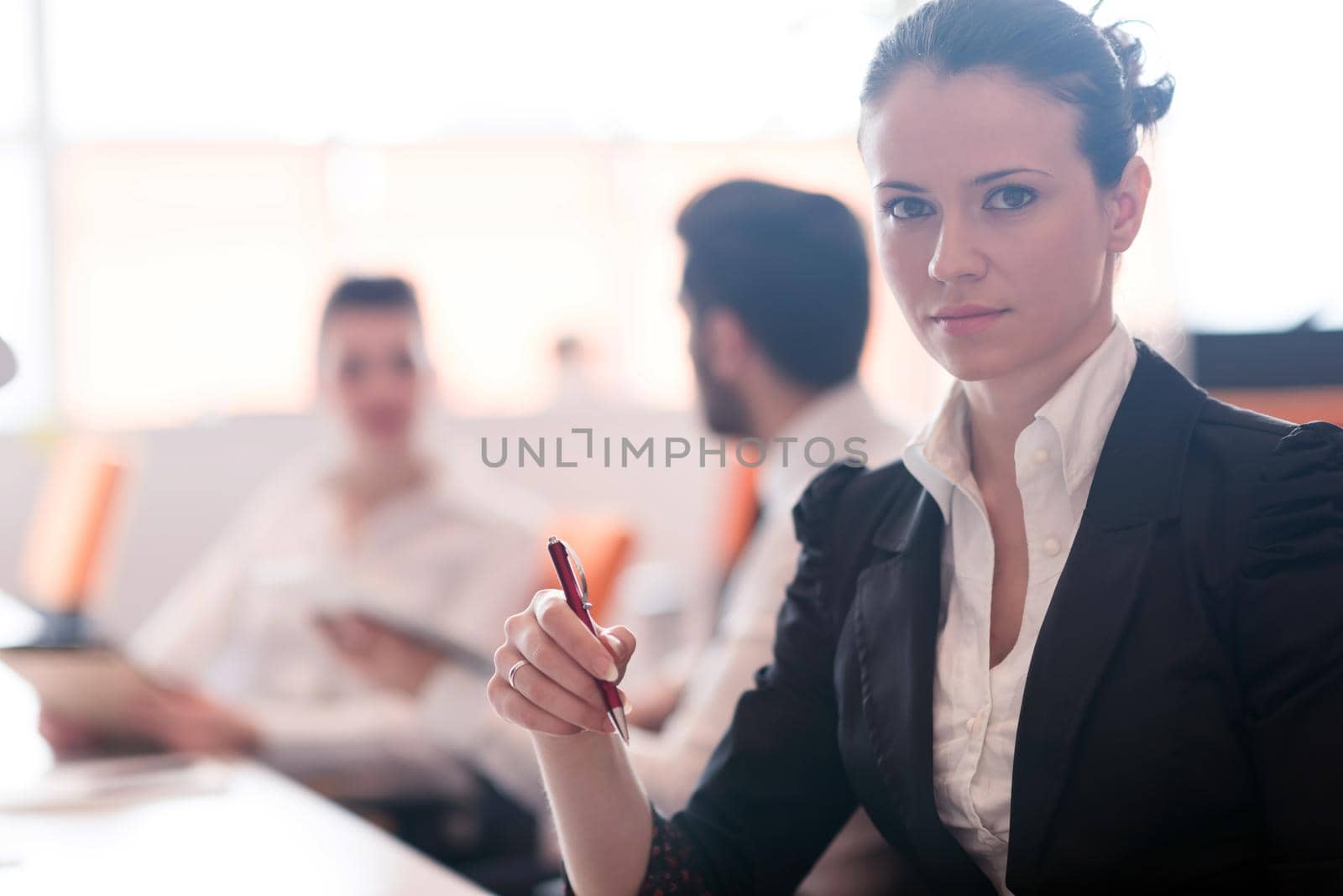 portrait of woman while holding pen on business meeting by dotshock