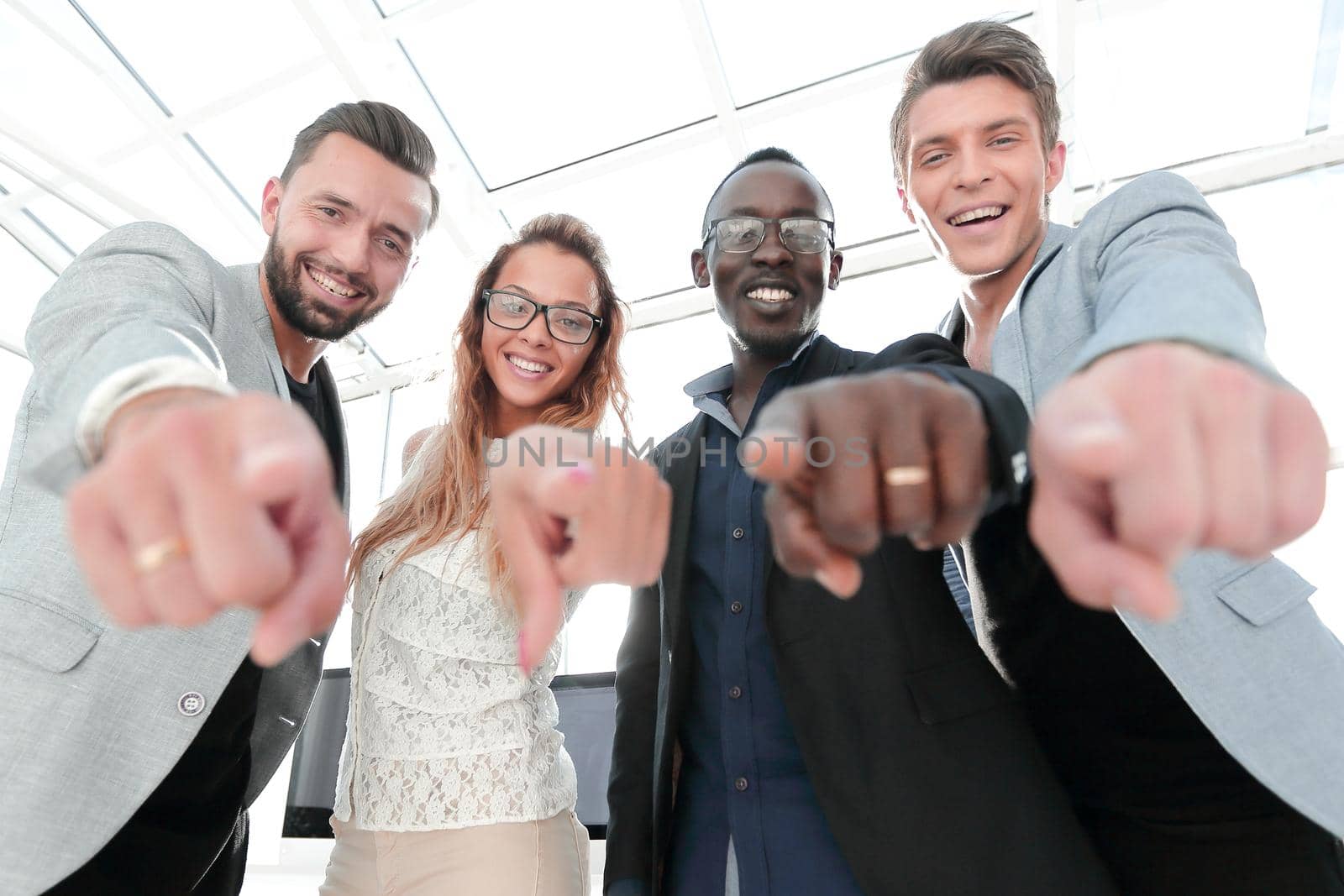multinational business team points their fingers at you.the concept of choice
