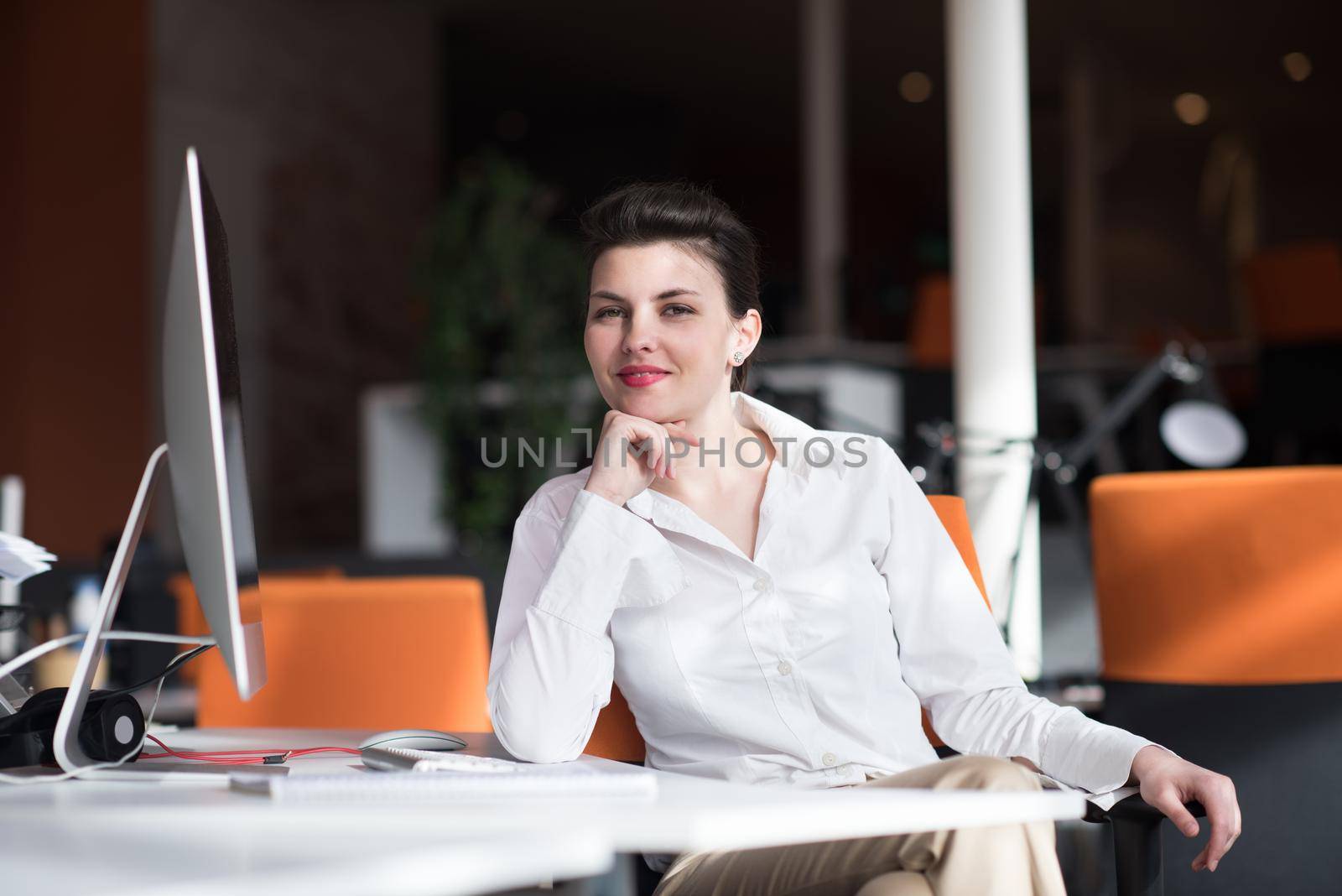 happy young business woman relaxing and geting insiration while working on desktop computer at modern bright  starup office interior