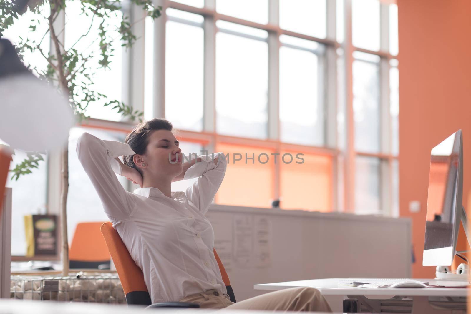 happy young business woman relaxing and geting insiration while working on desktop computer at modern bright  starup office interior
