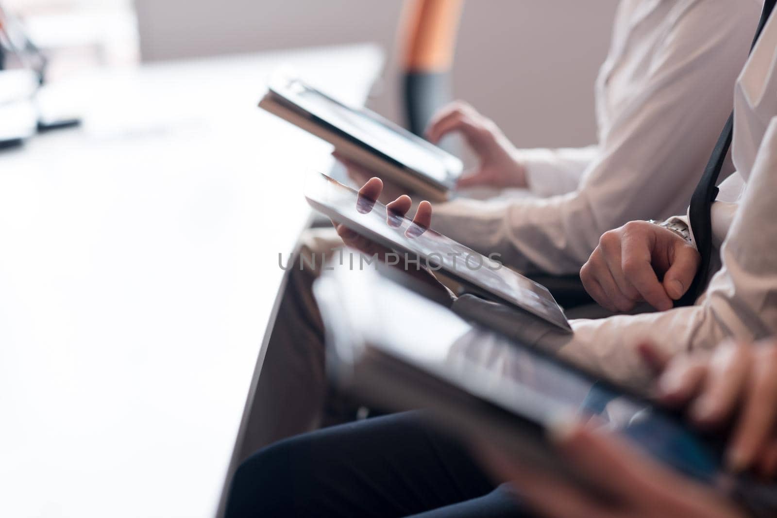 group of business people on meeting  using tablet computer in modern bright startup office interior