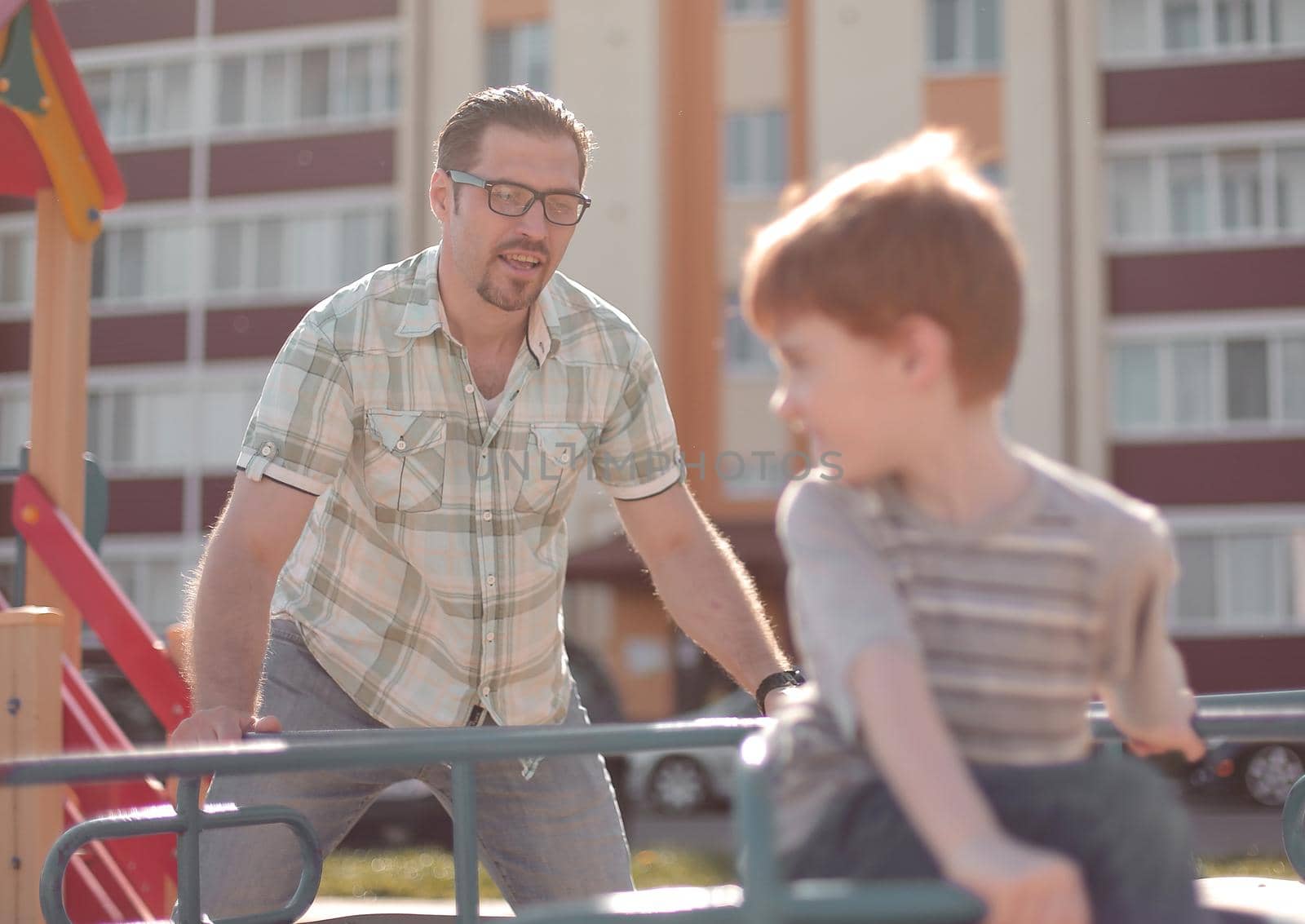 happy father playing with little boy on the Playground.the concept of parenting