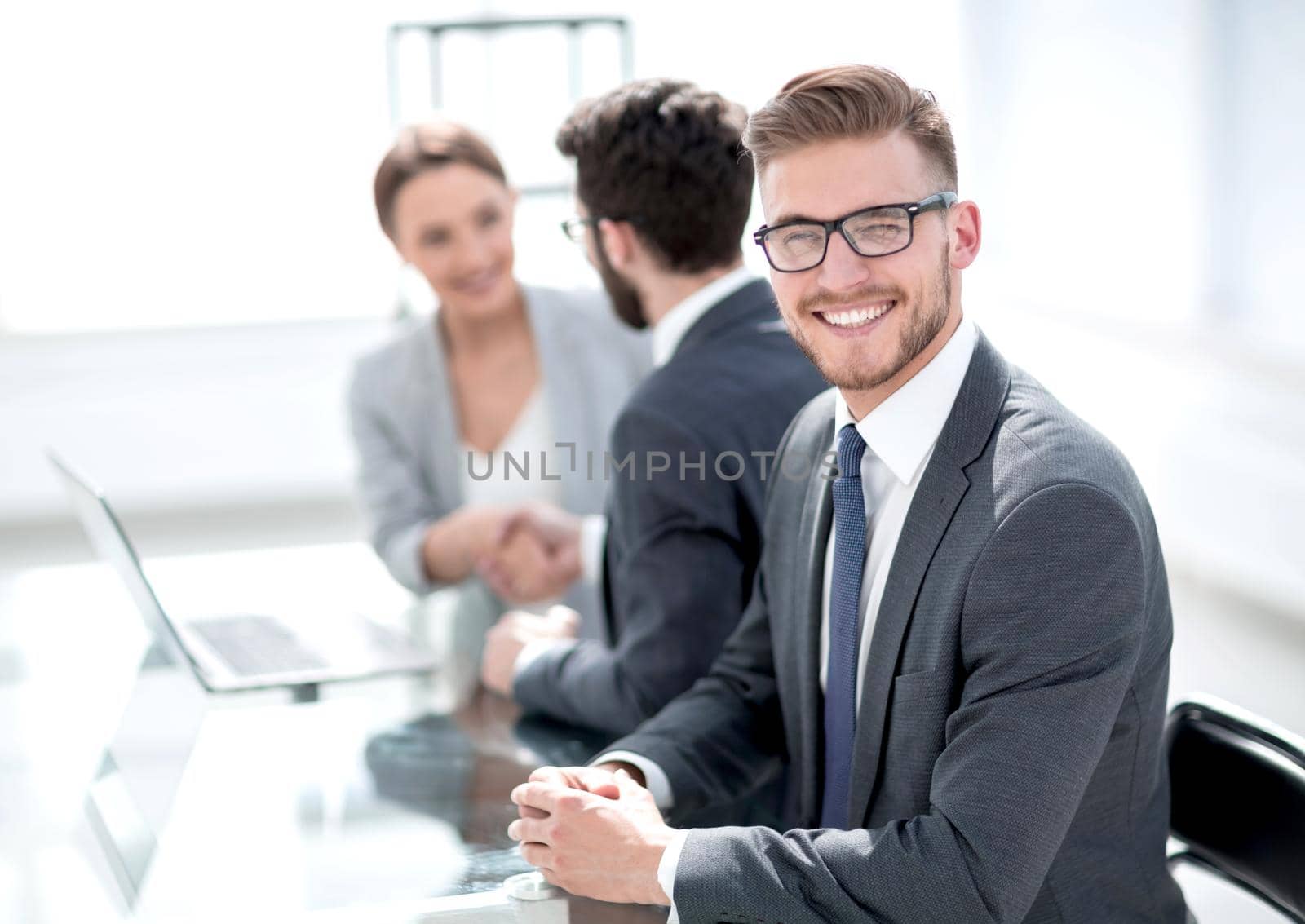 side view.successful businessman sitting at his Desk.photo with copy space