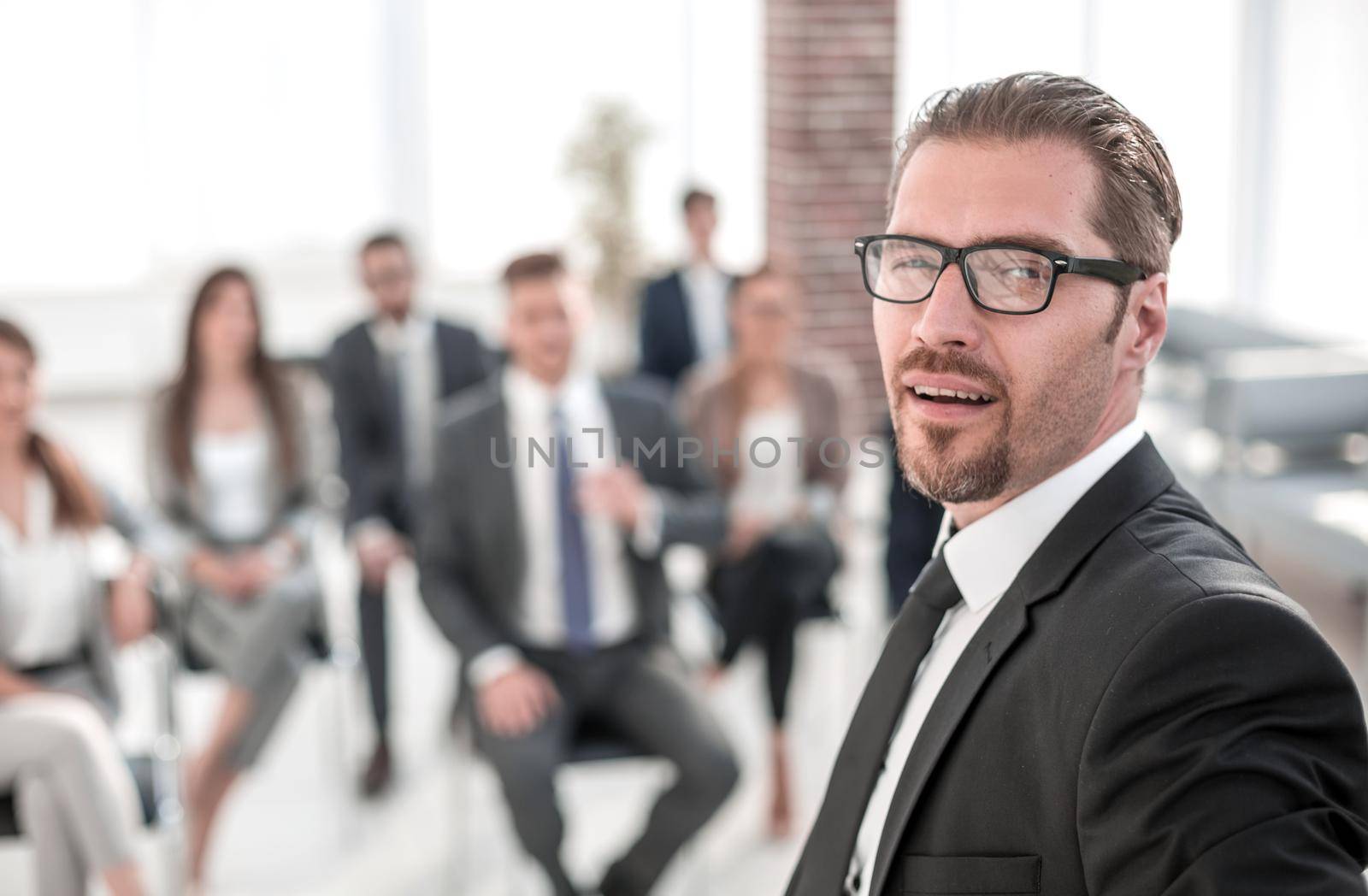 confident businessman on the background of the conference room by asdf