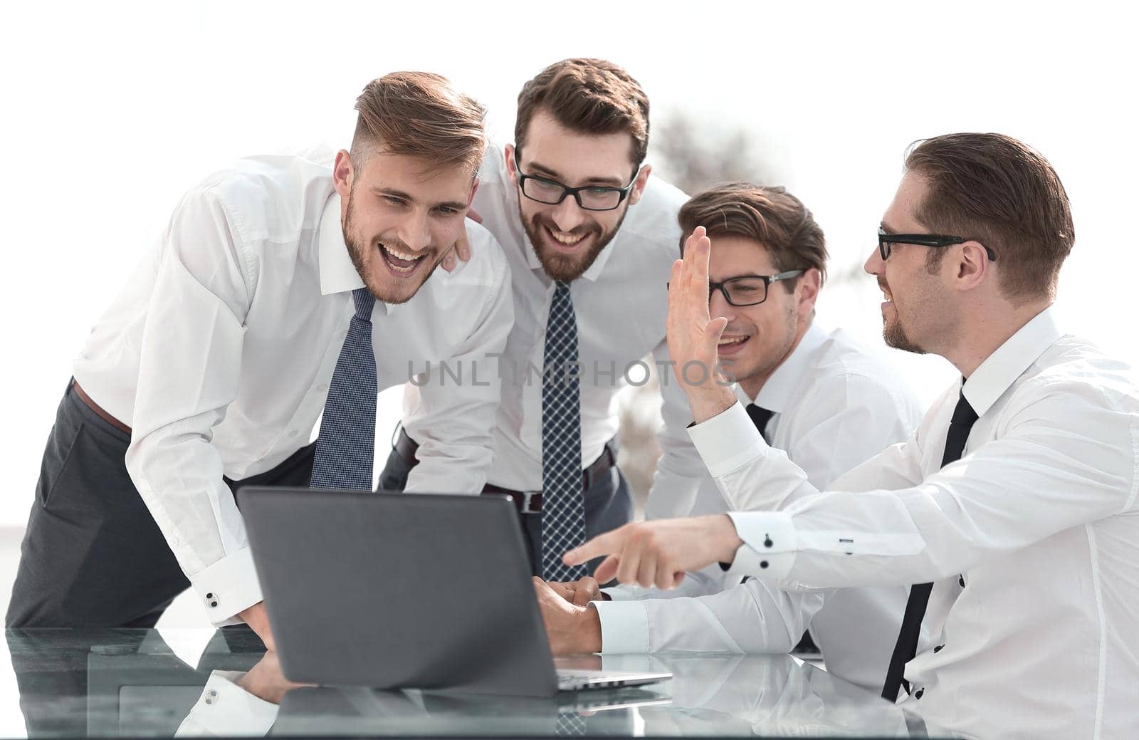 Happy excited team looking at the laptop screen.start-up