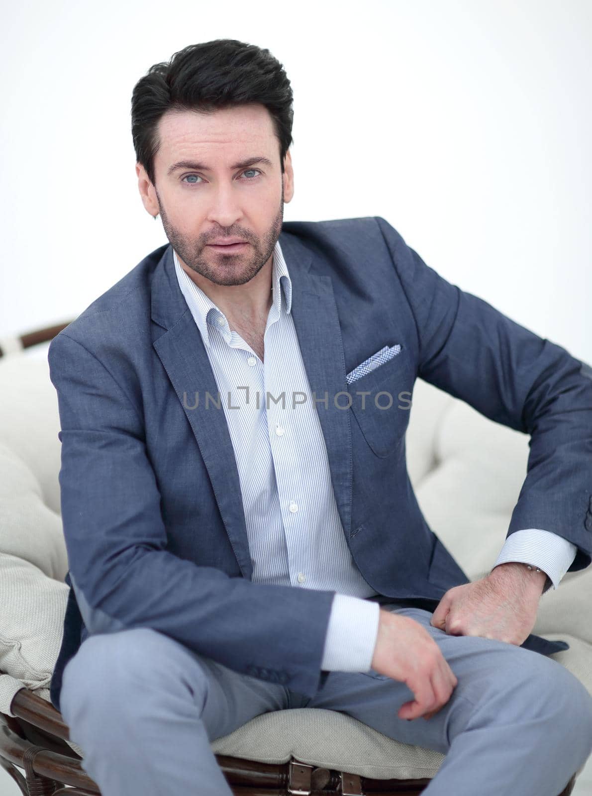 close up.serious businessman sitting in a comfortable chair. by asdf