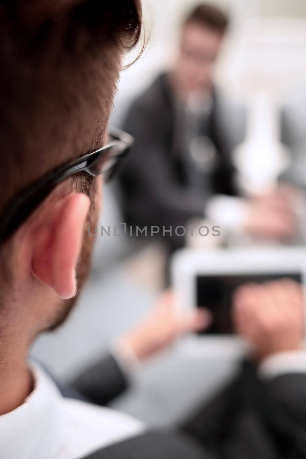 business background.blurred image of a businessman with a digital tablet.business concept