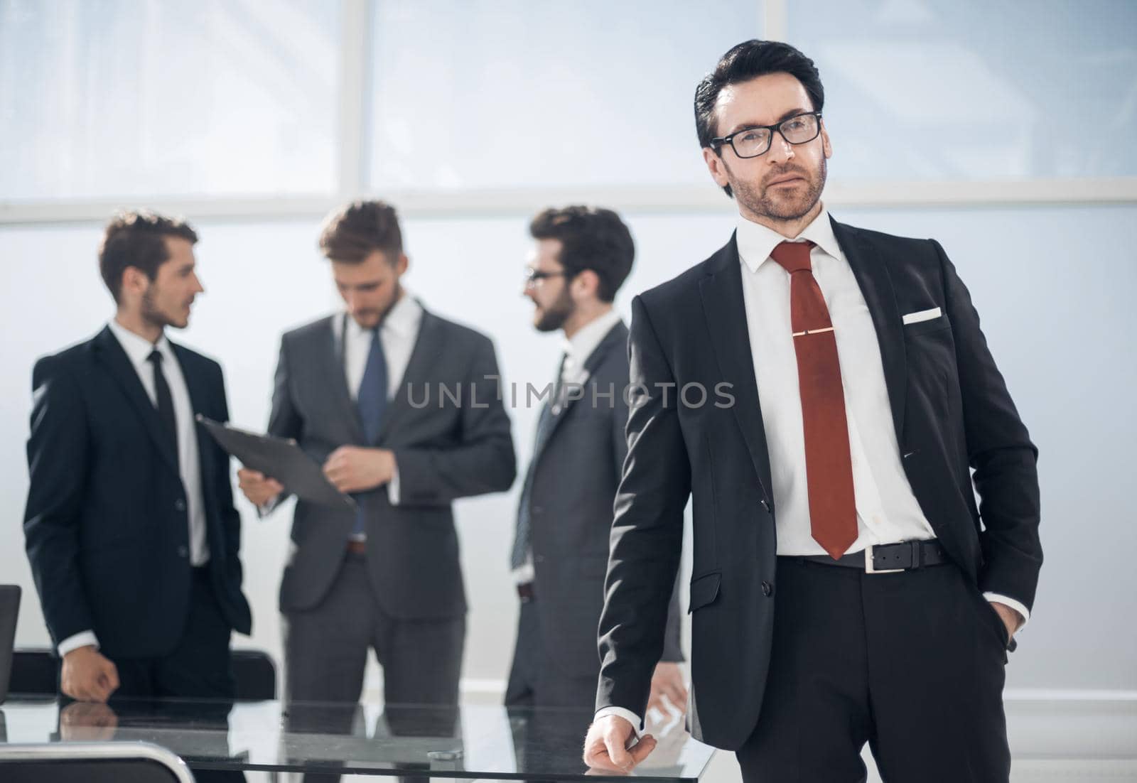 successful businessman standing in the office by asdf