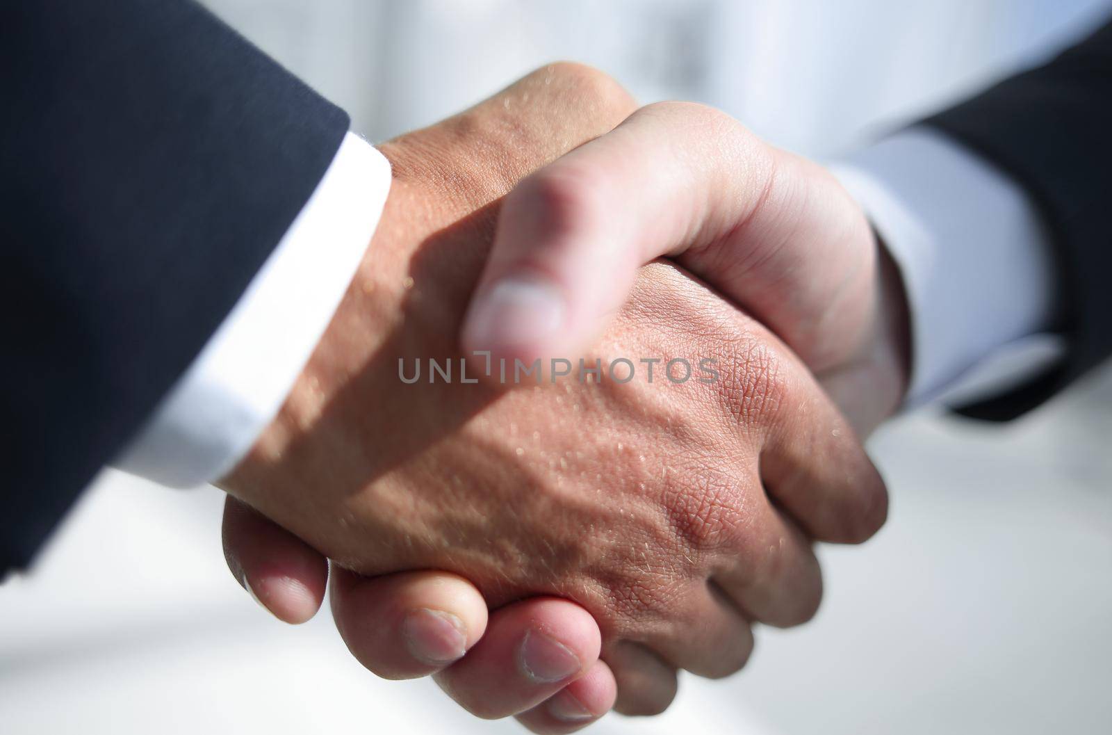 business meeting, handshake close up in office background