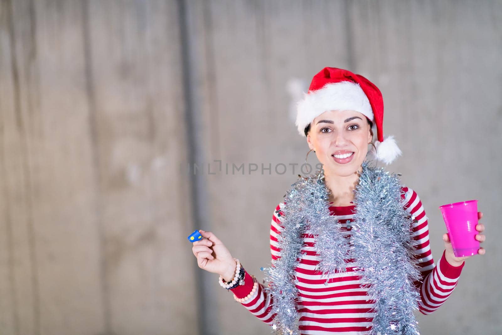 young business woman wearing a red hat and blowing party whistle by dotshock