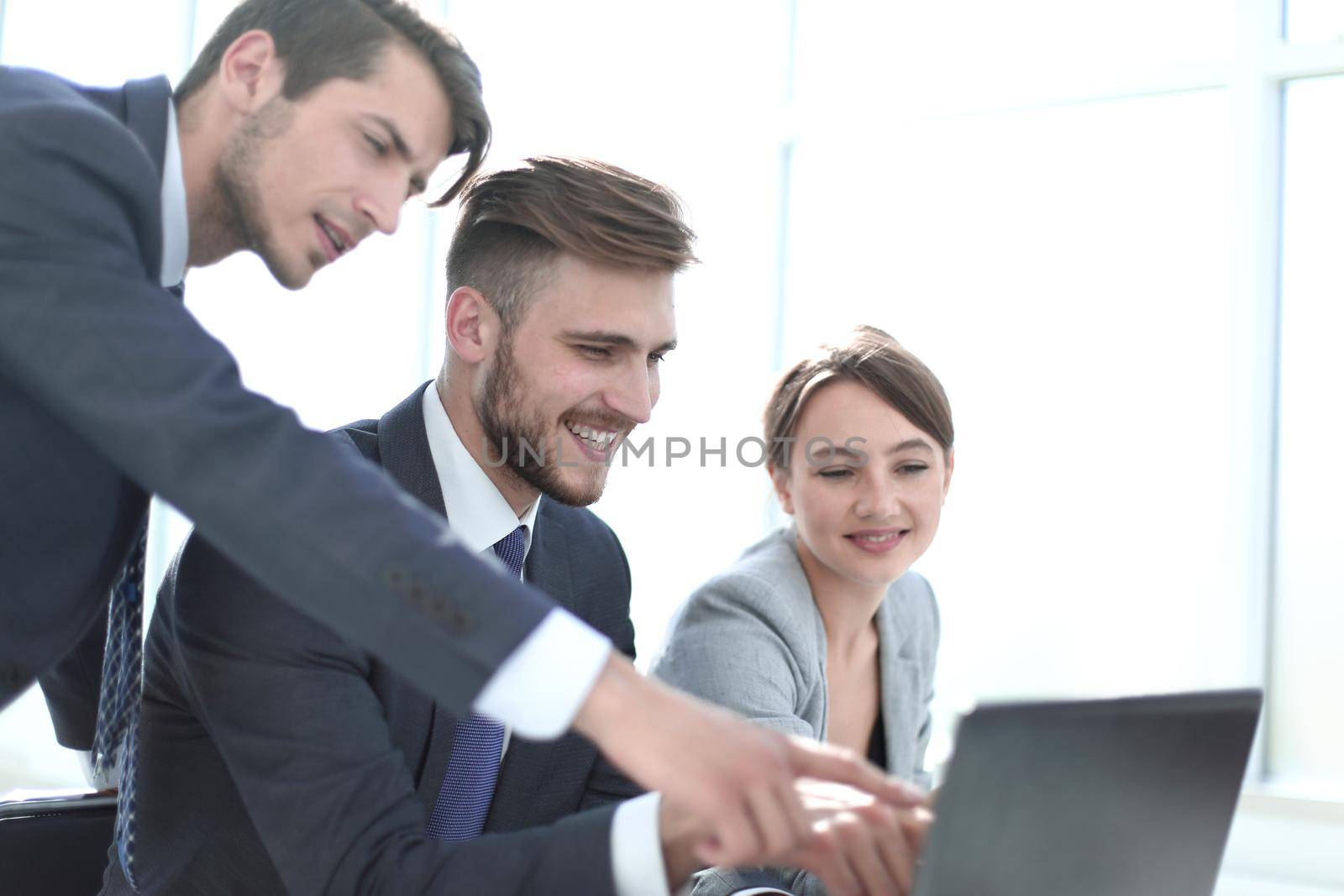 business team uses a laptop in the office by asdf