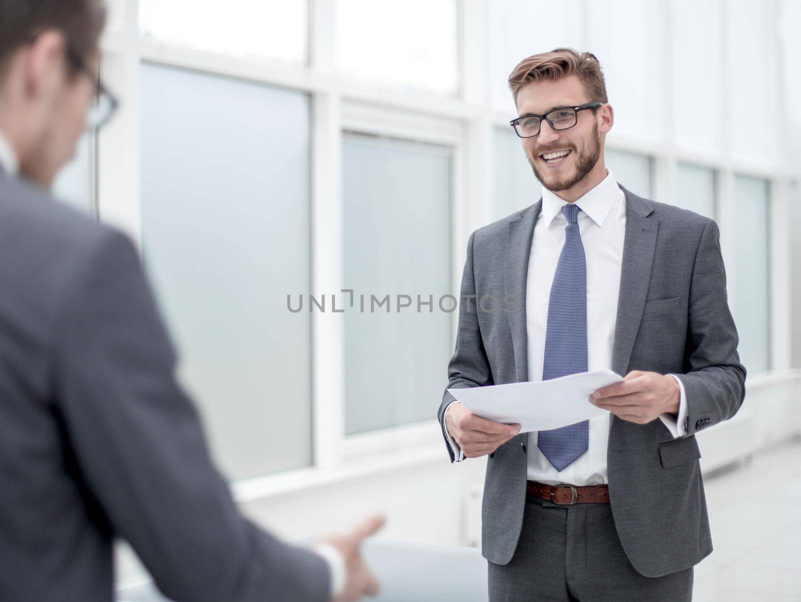 businessman reading a working paper standing in the office.photo with copy space