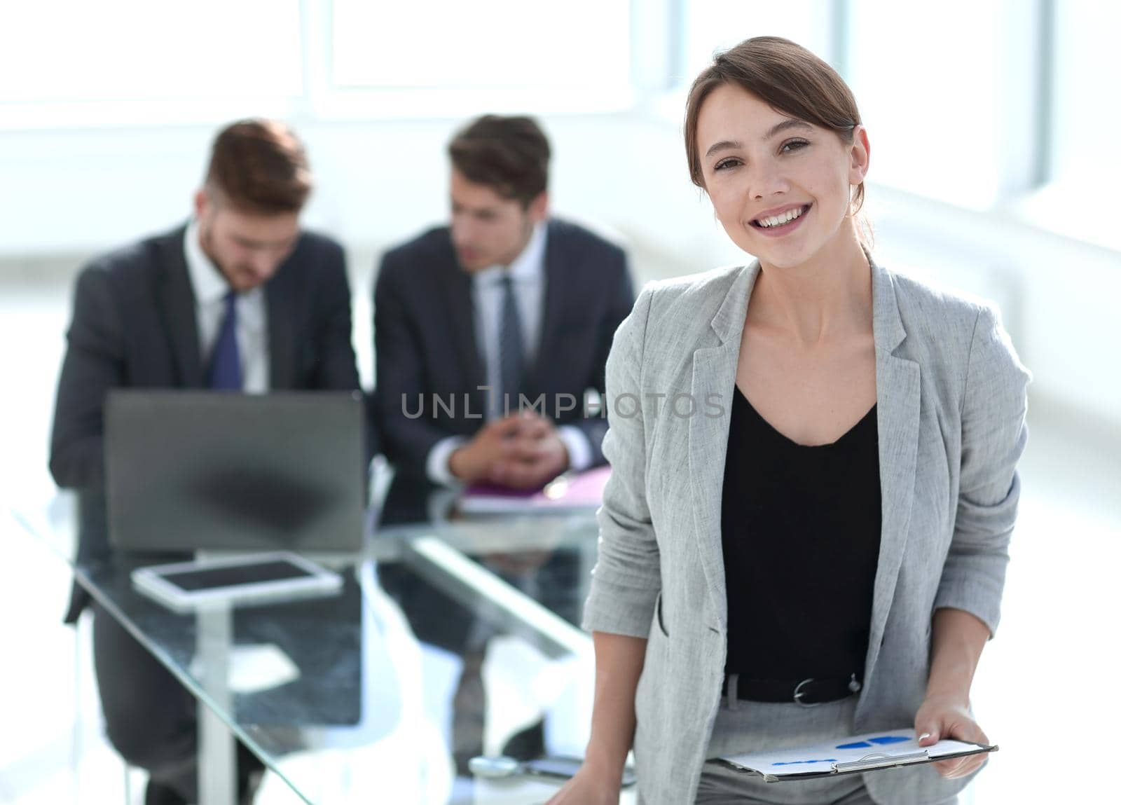 successful business woman standing near office Desk by asdf