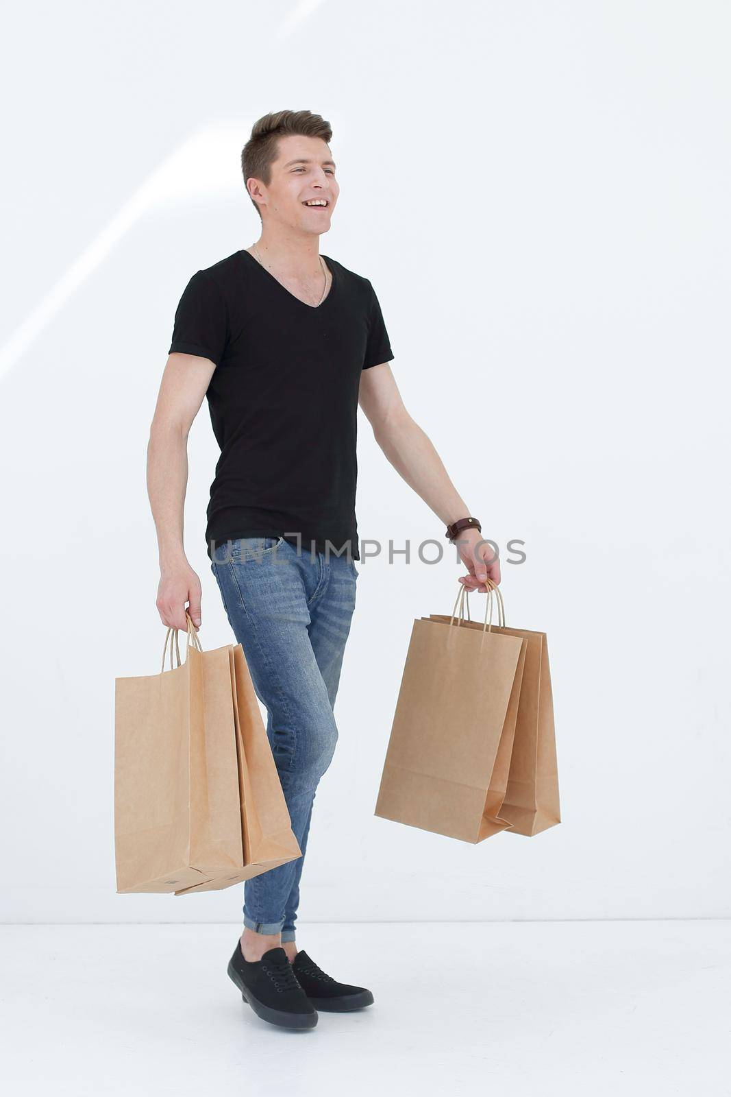 Handsome man in a black T-shirt with a bag by asdf