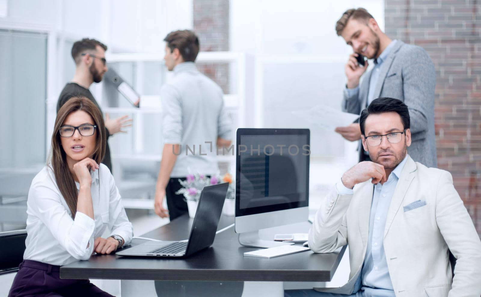 businessman and businesswoman sitting at the office Desk.photo with space for text
