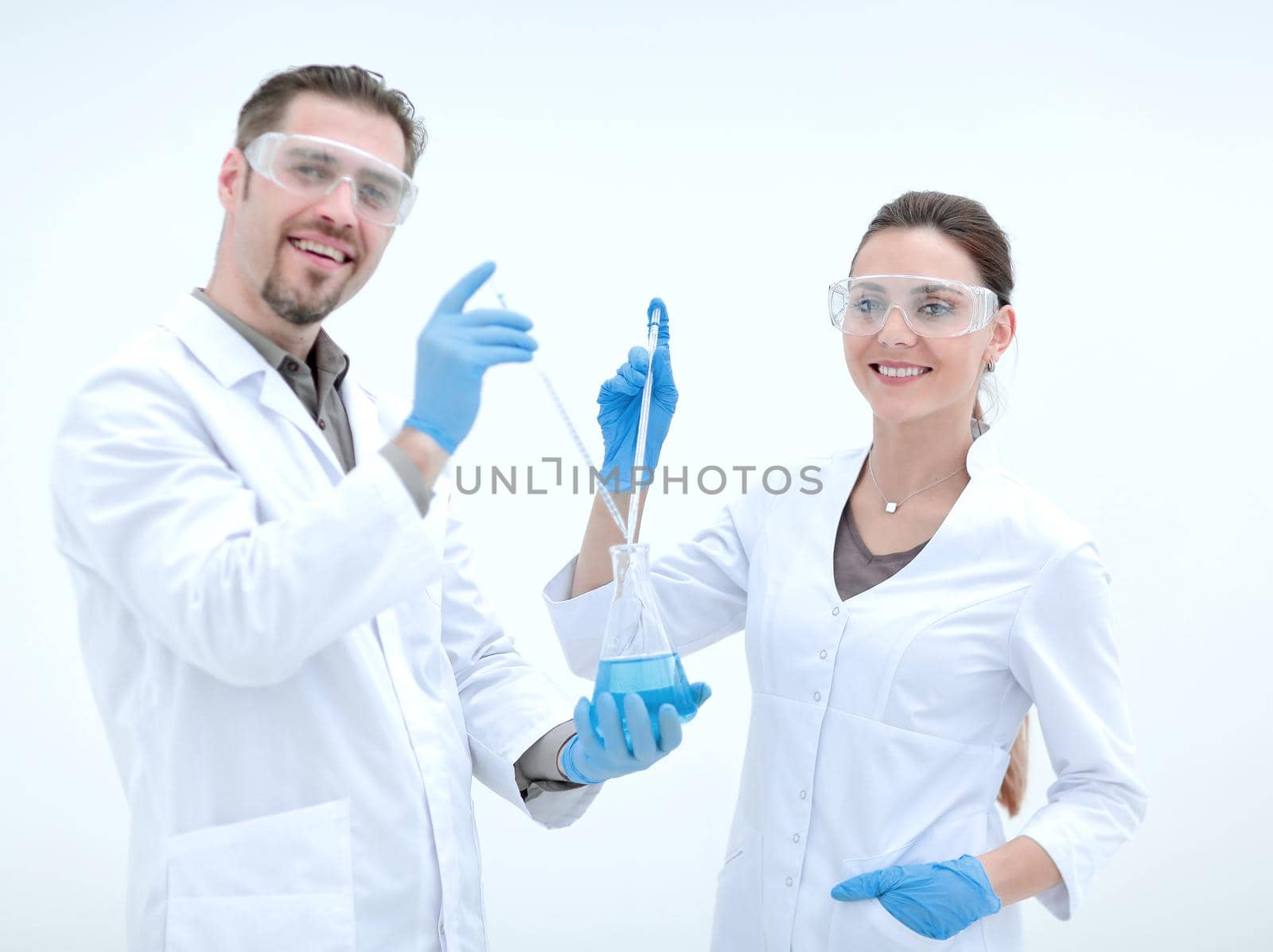 two cheerful scientists biologist on a light background.science and research