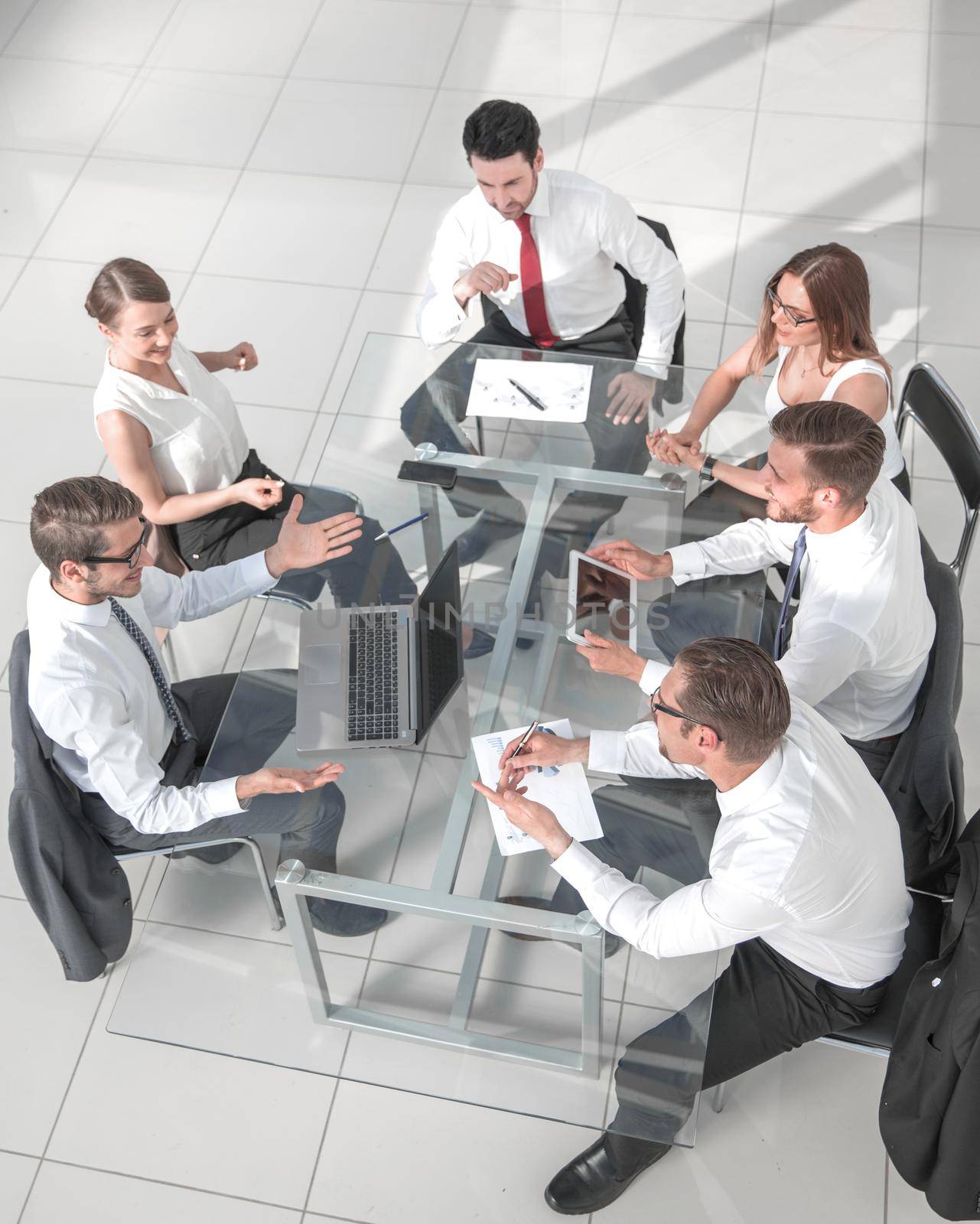High angle view of multi-ethnic business people discussing in board room meeting