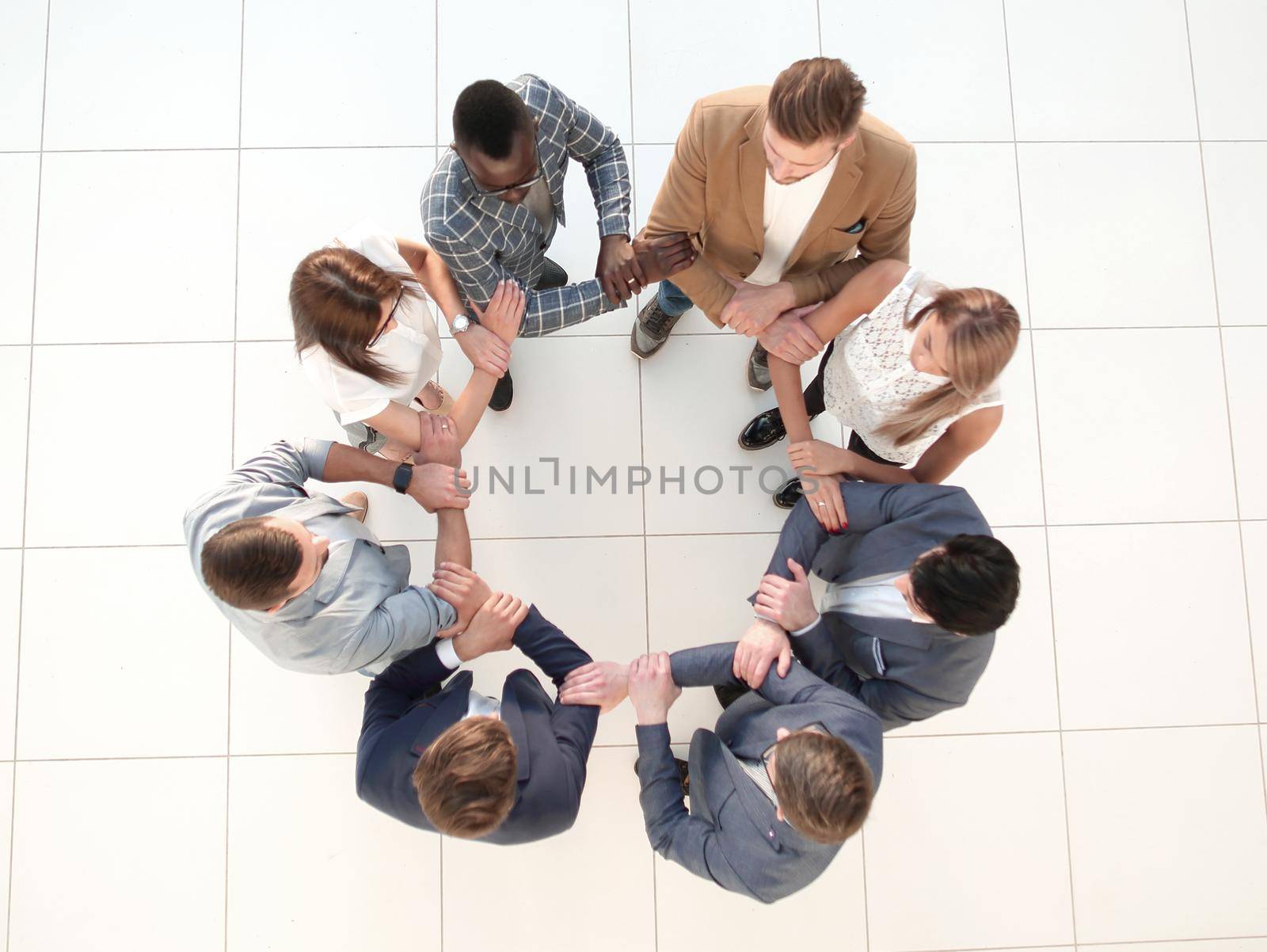 top view.the business team holds each other's hands by asdf