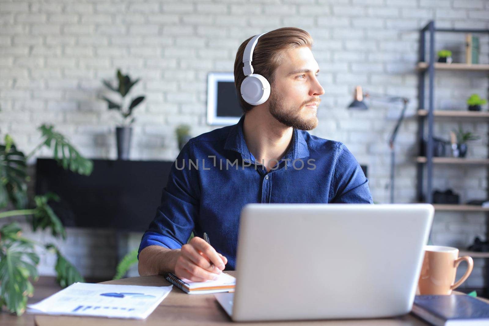 Confident man wearing headset speaking and watching business webinar training, listening to lecture. by tsyhun