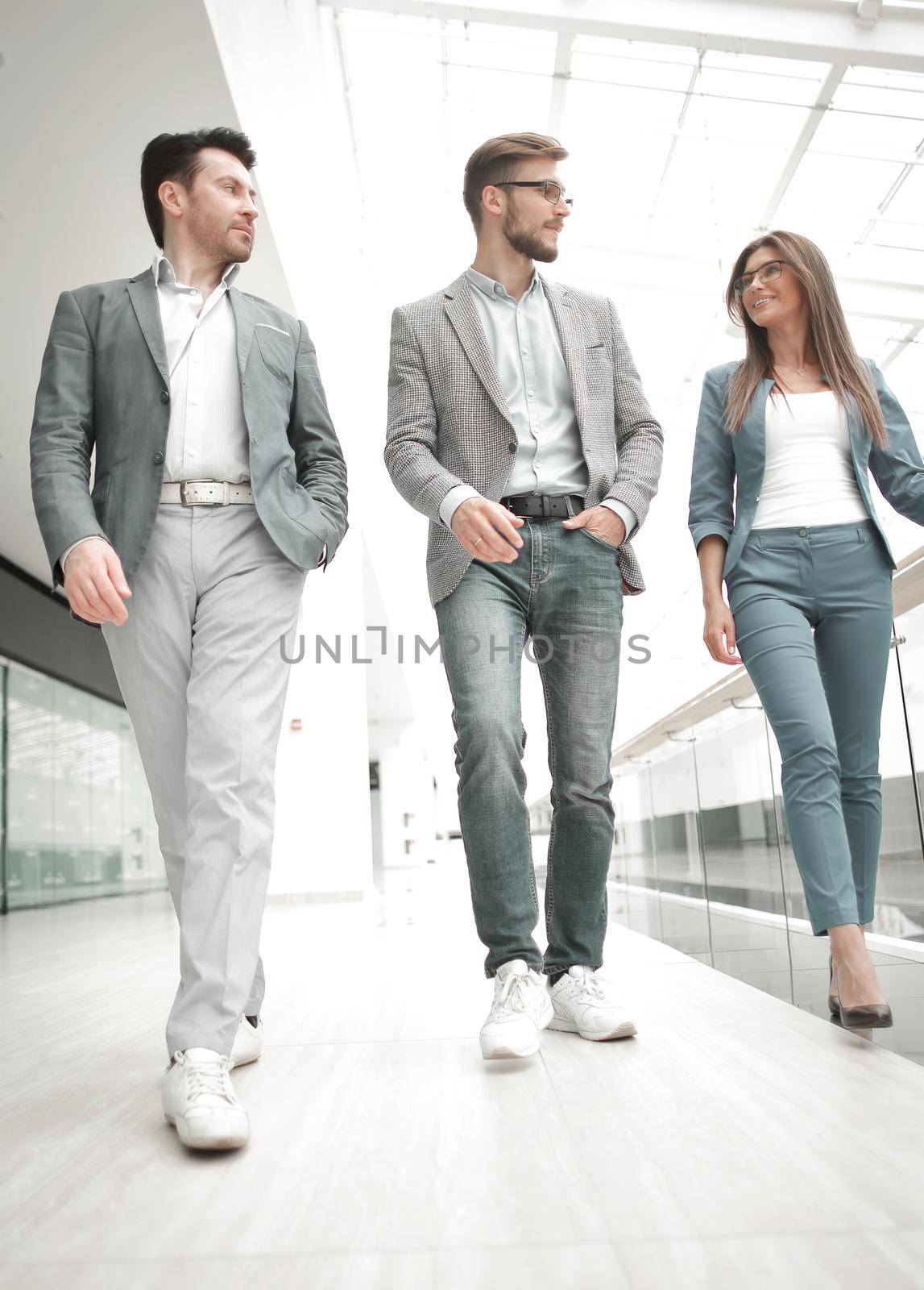 group of business people in the office hall by asdf