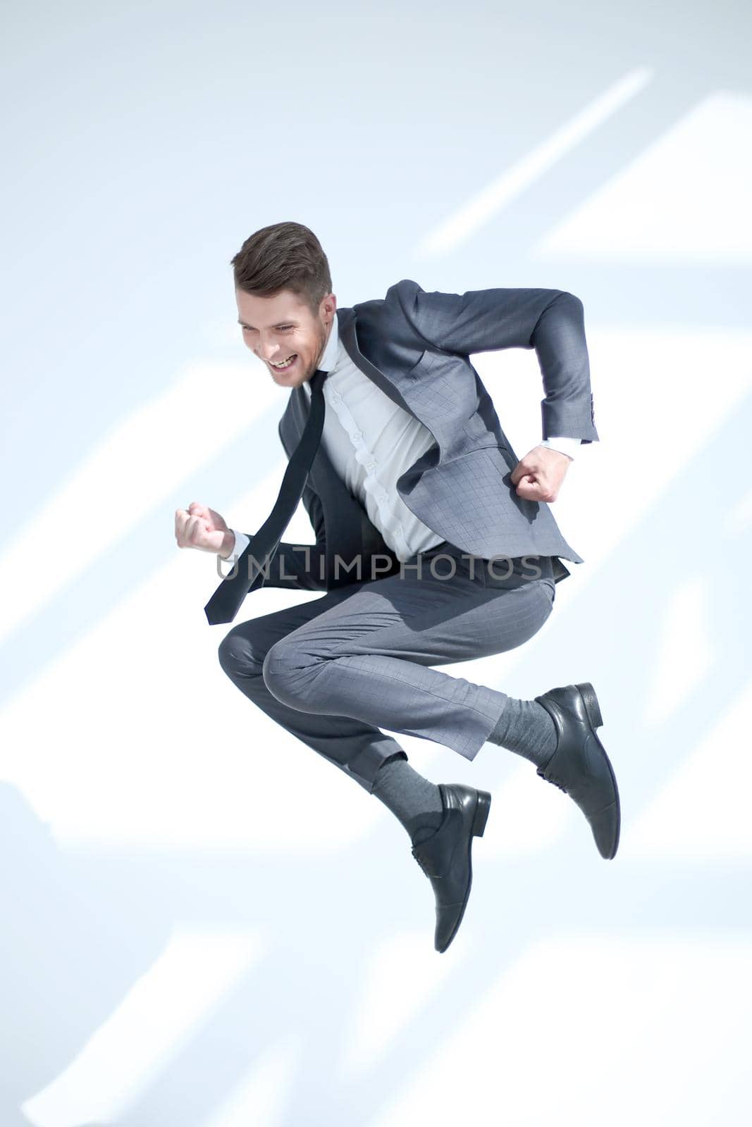 Young excited man jumping up in a jump, isolated on a white background.