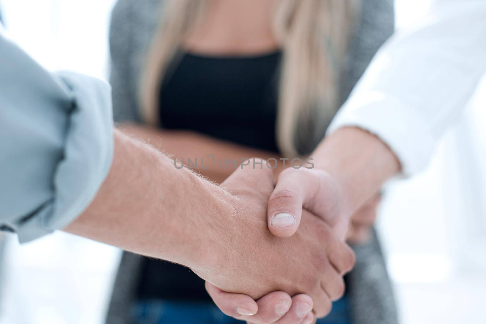 Close-up of business partners shaking hands in a meeting by asdf