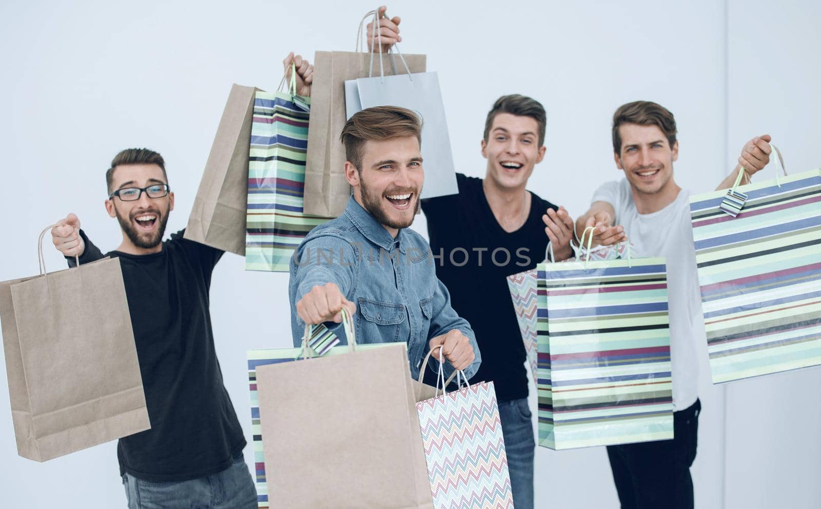 group of cheerful young people with shopping bags